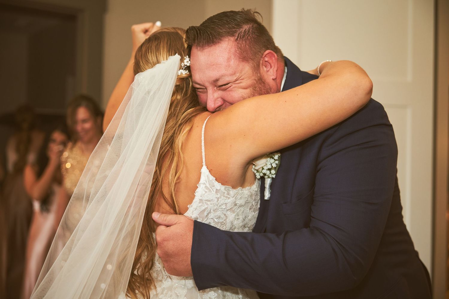 Two people sharing an emotional embrace during a wedding ceremony.