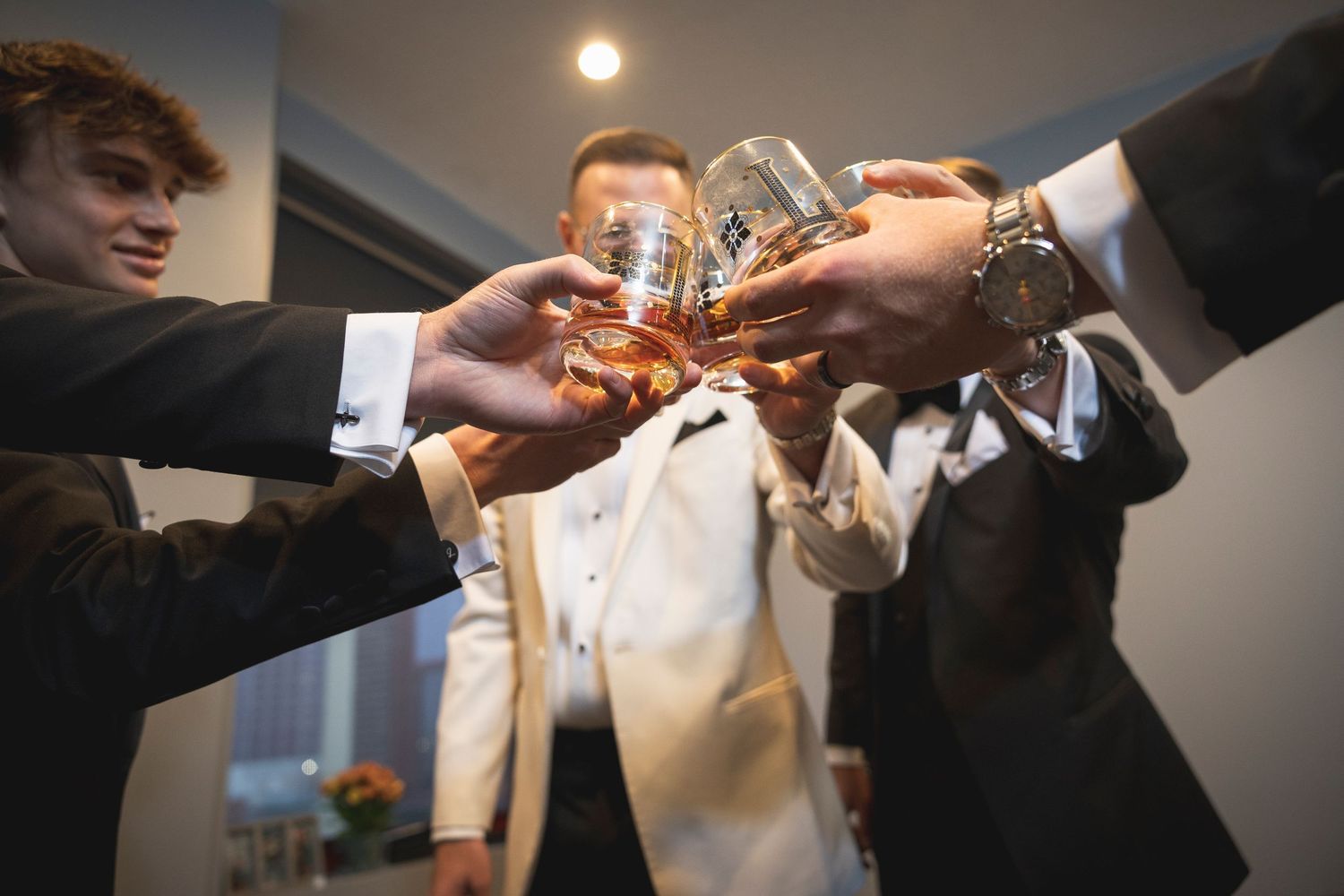 Close-up shots of hands clinking champagne glasses in celebration.