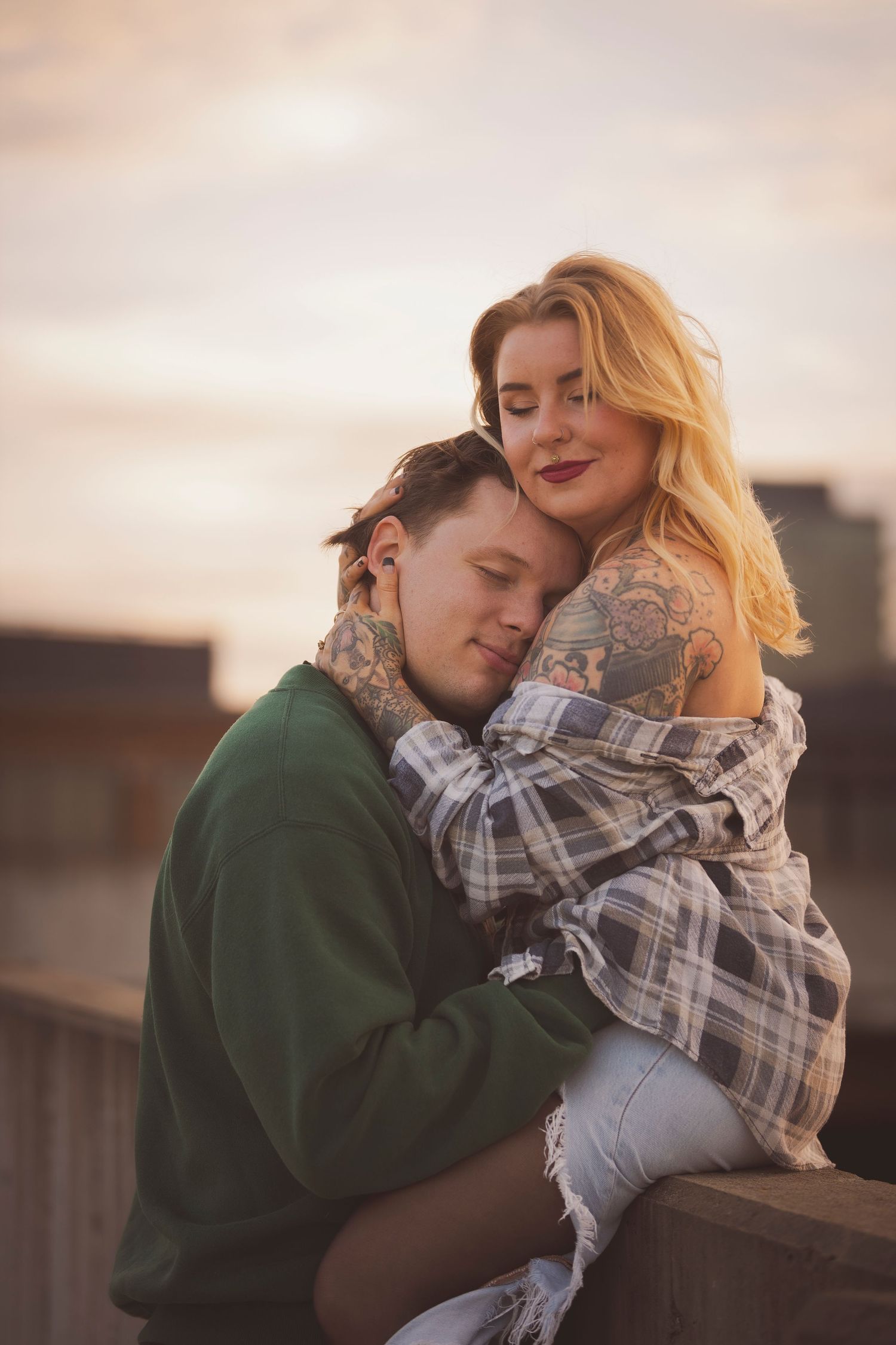 Two people sharing tender moment at dusk outdoors.