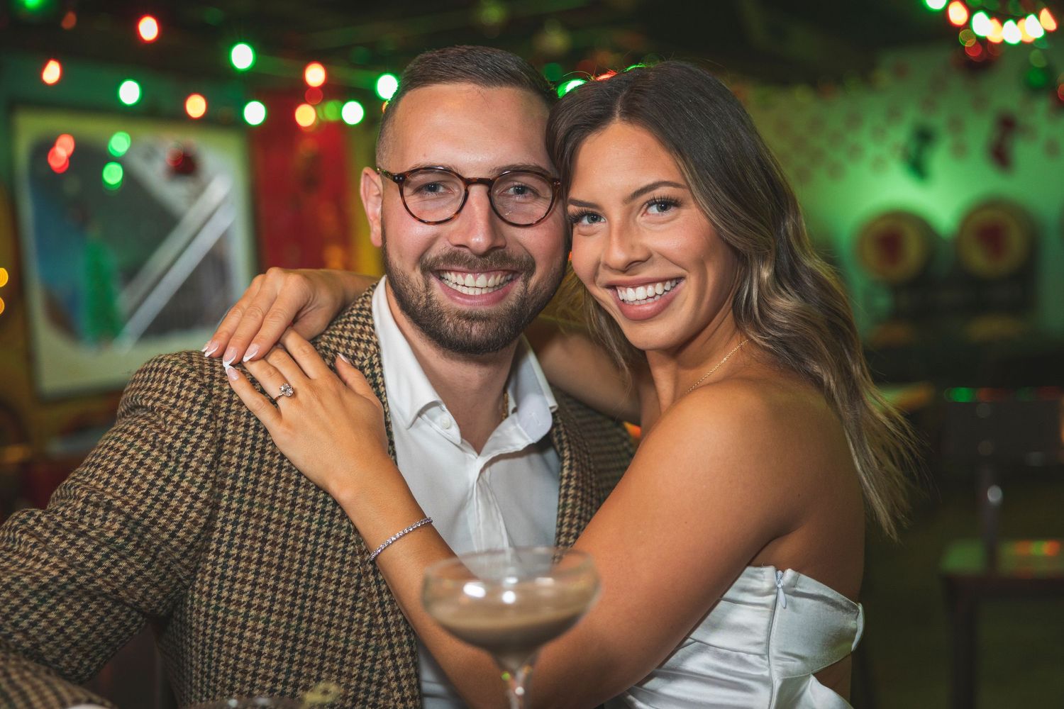Festive bar scene with string lights creating a romantic atmosphere for a couple.