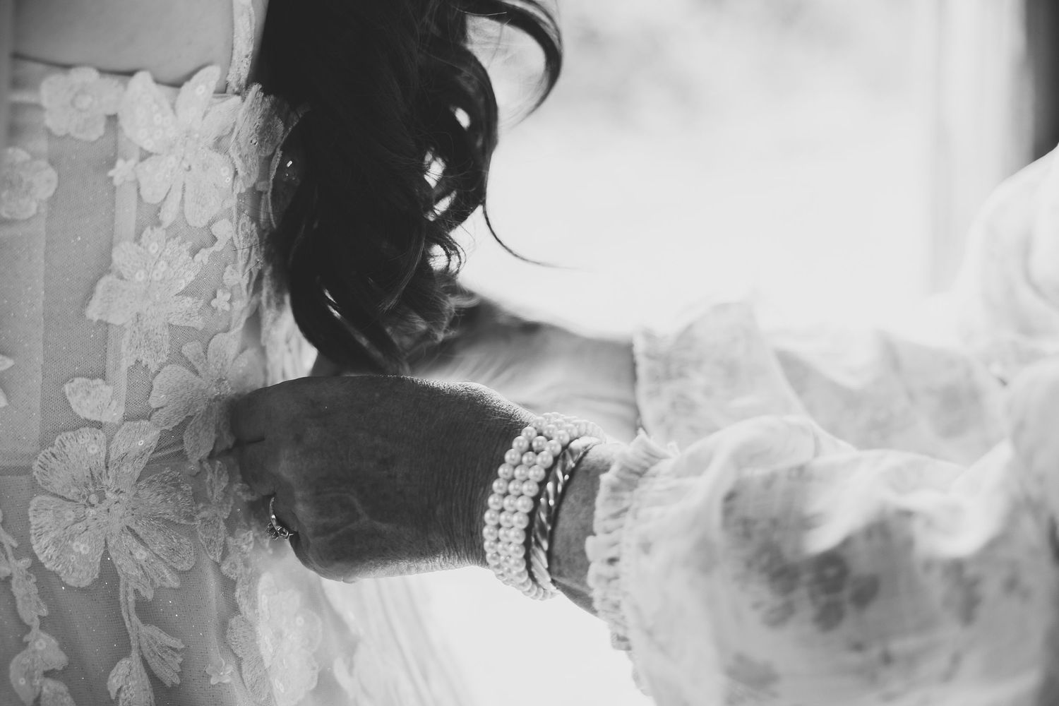 Ethereal black and white photograph with delicate lace details and soft focus effects.