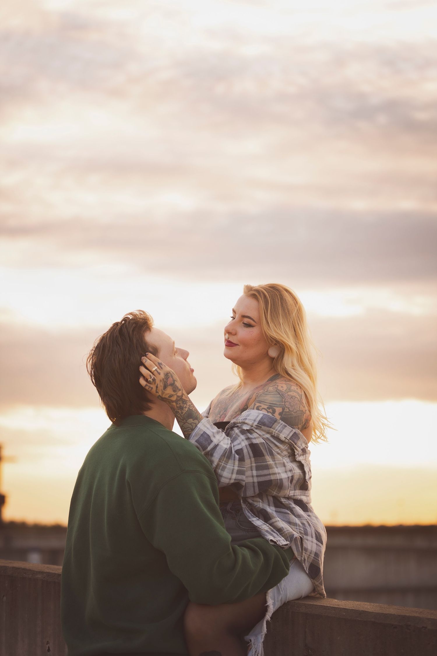 Couple sharing an intimate embrace during golden sunset outdoors.