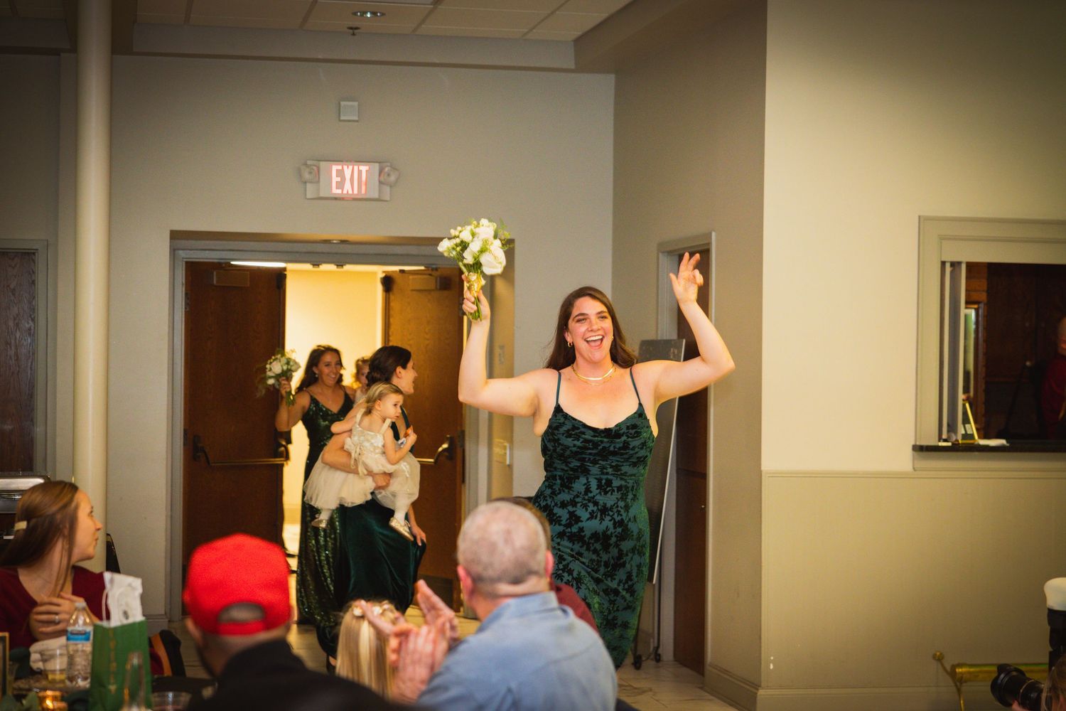 Indoor event space with people mingling during a celebration.