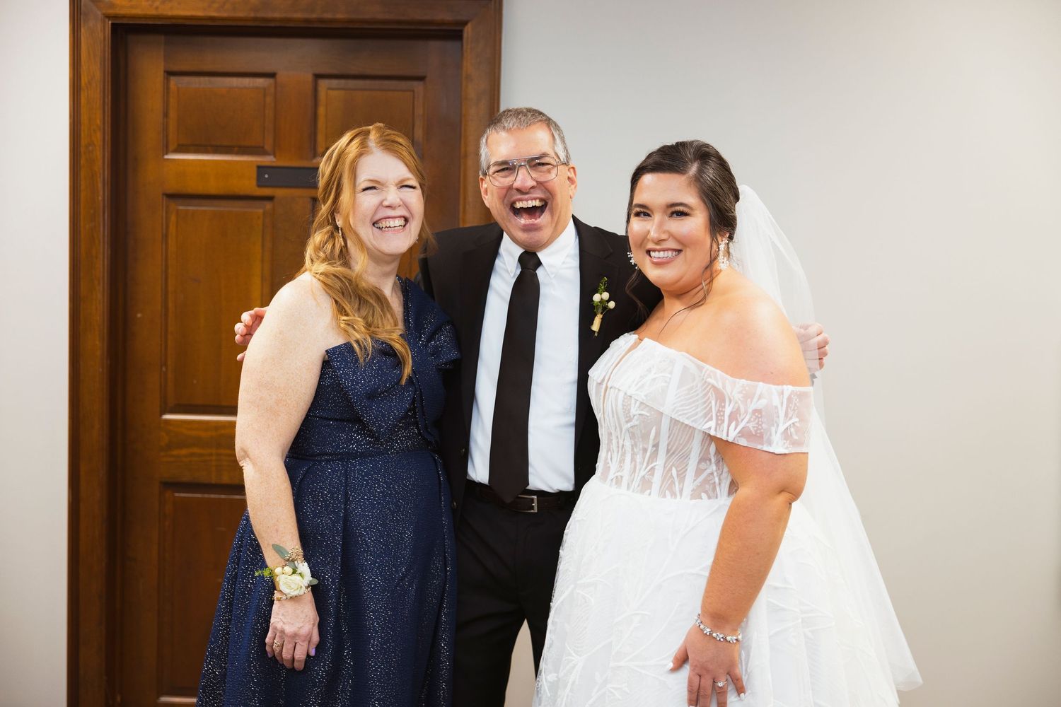 Wedding party members sharing joyful moments before the ceremony.