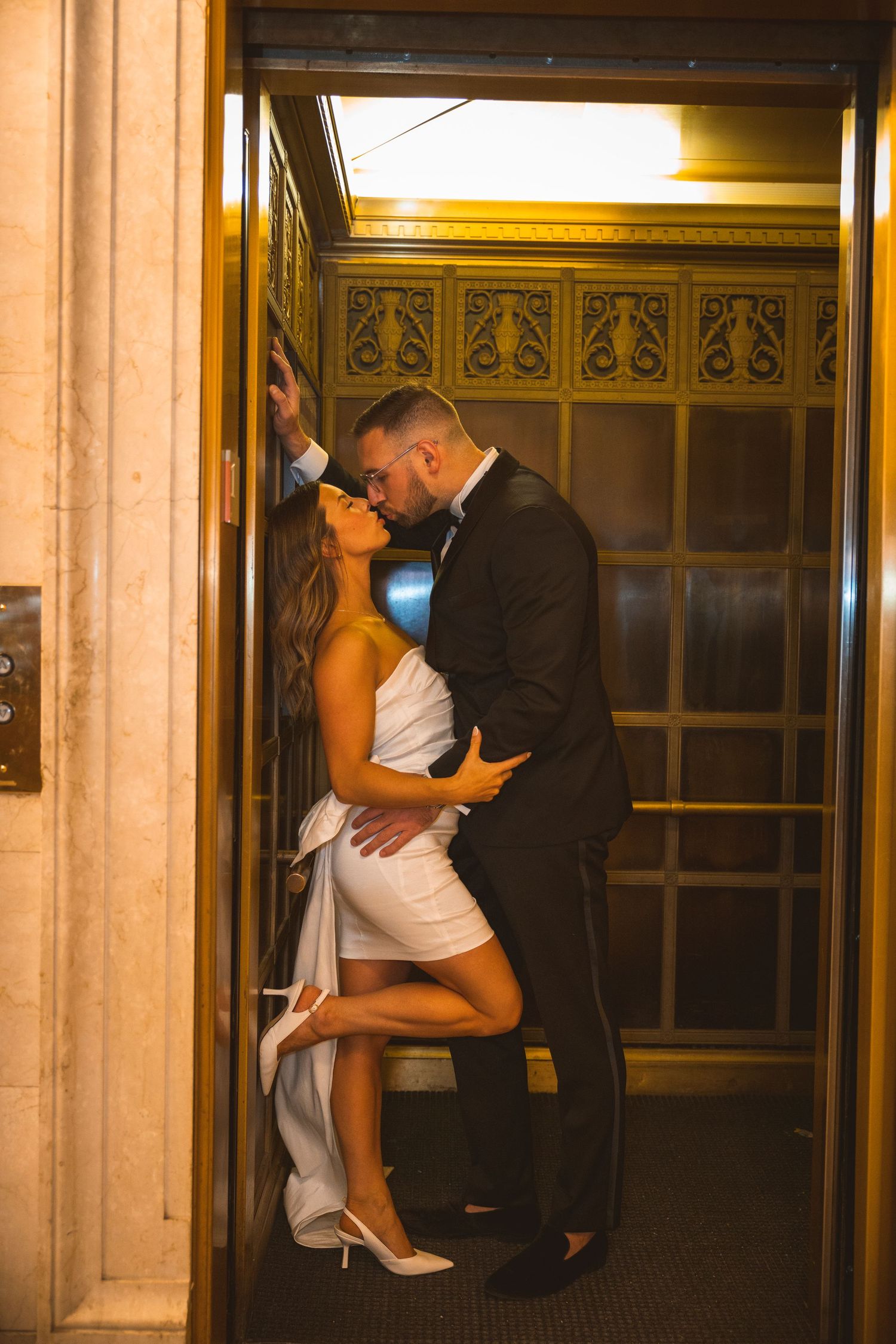 Romantic dance sequence in a warmly lit historic doorway.