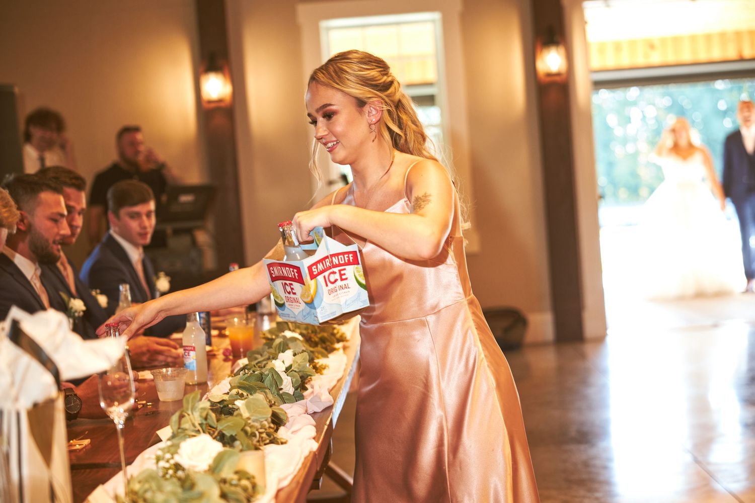 Wedding reception venue with rustic decor and floral centerpieces in natural light.