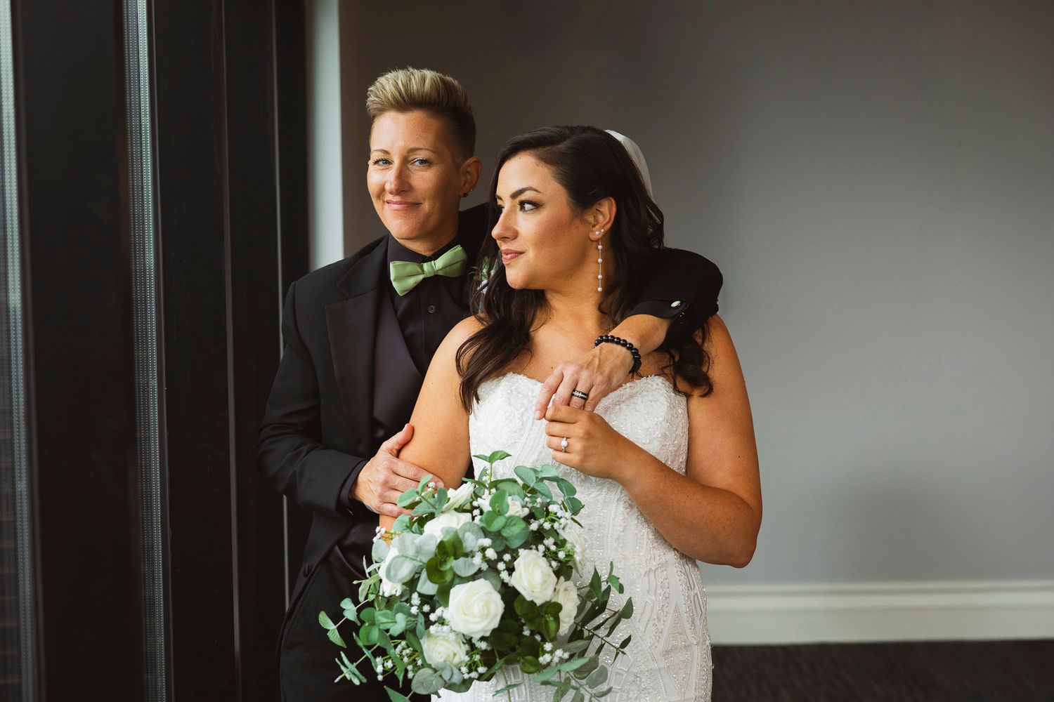 A wedding couple shares an intimate moment in an indoor venue.