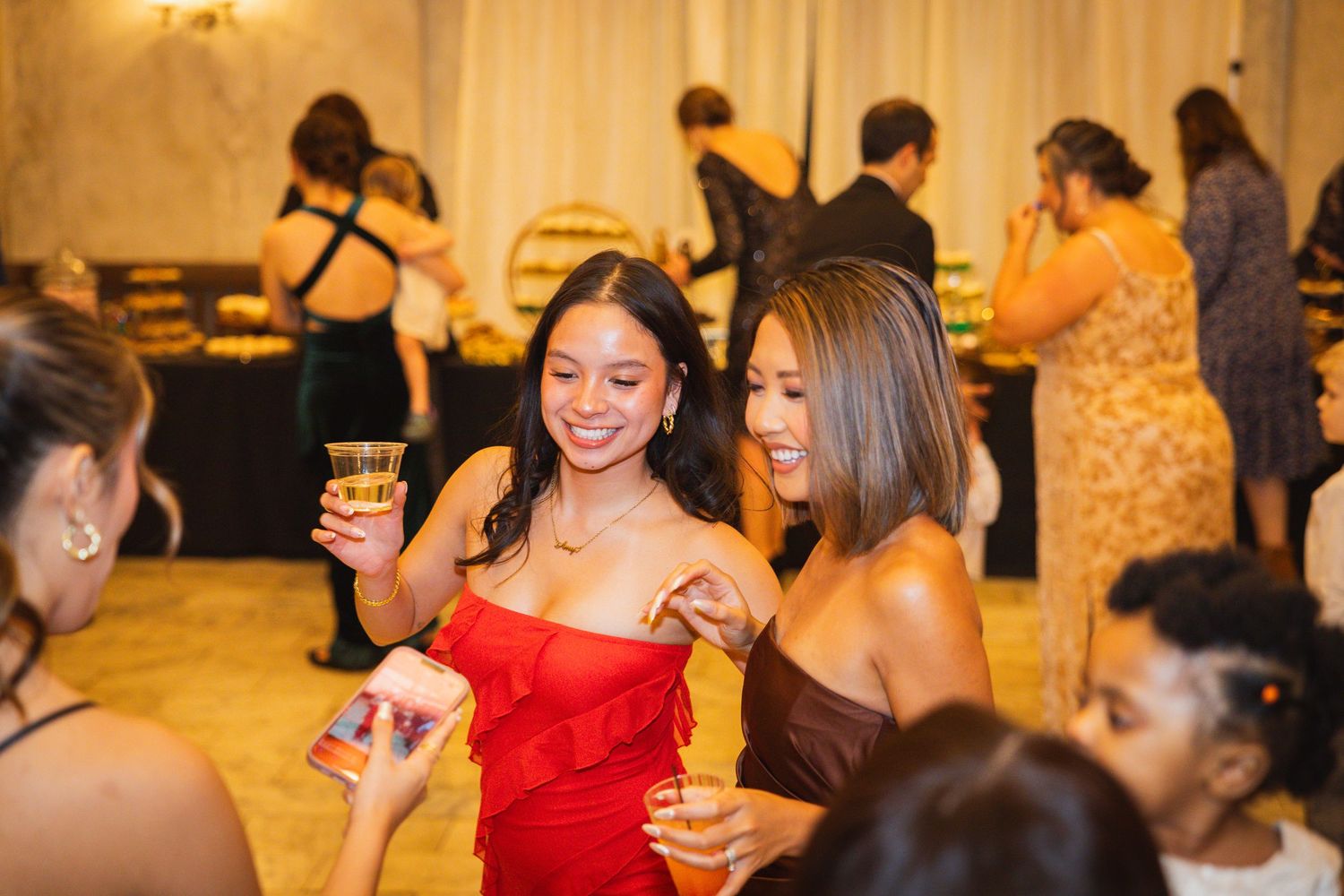 Festive reception venue with warm lighting and guests enjoying the celebration.