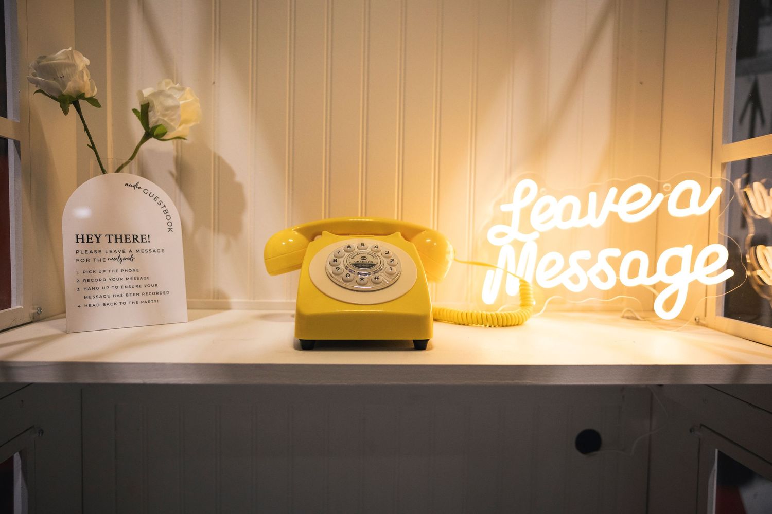 Illuminated text and decorative elements on a white shelf display.