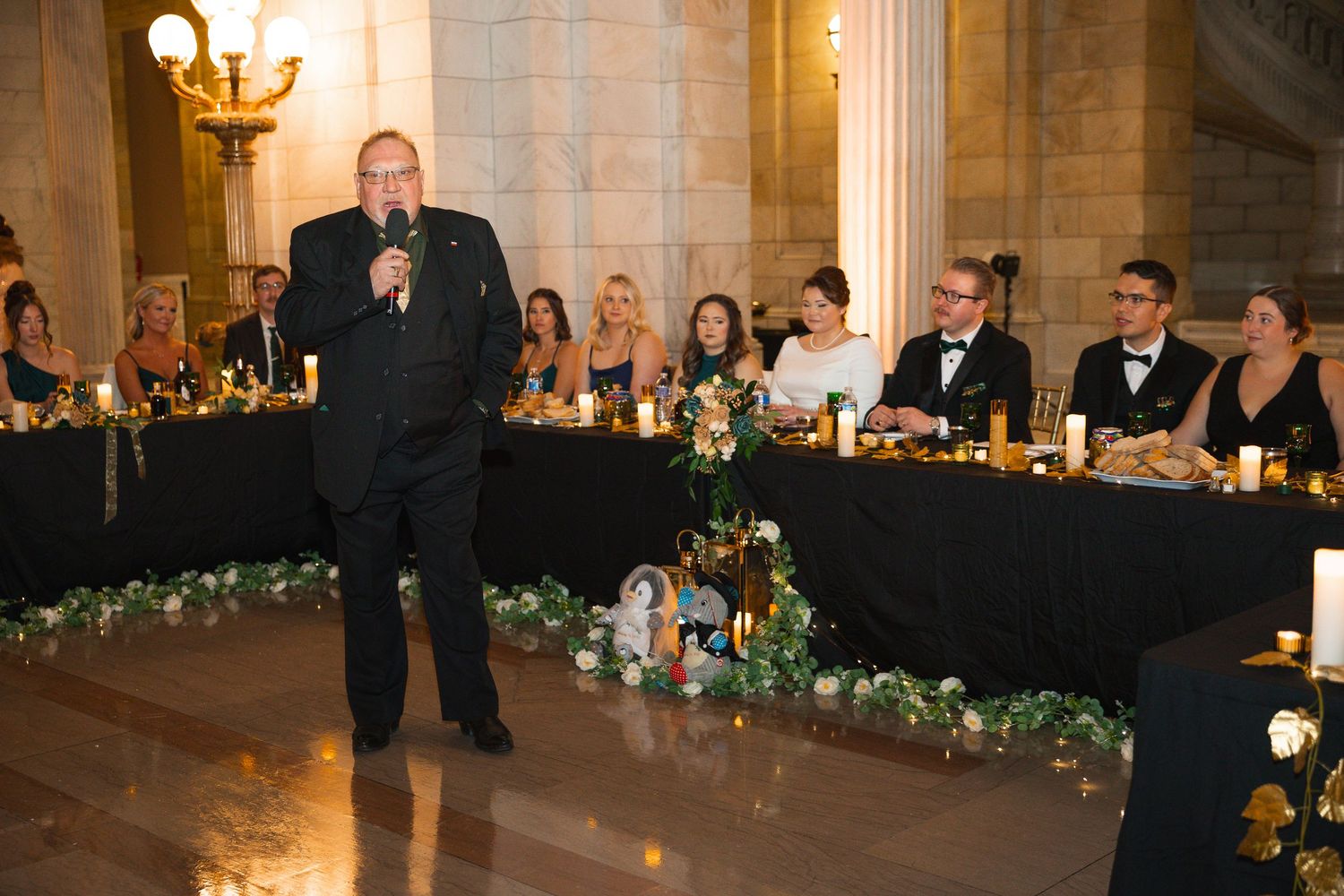 Wedding reception venue with beautiful columns and chandeliers creating an elegant atmosphere.