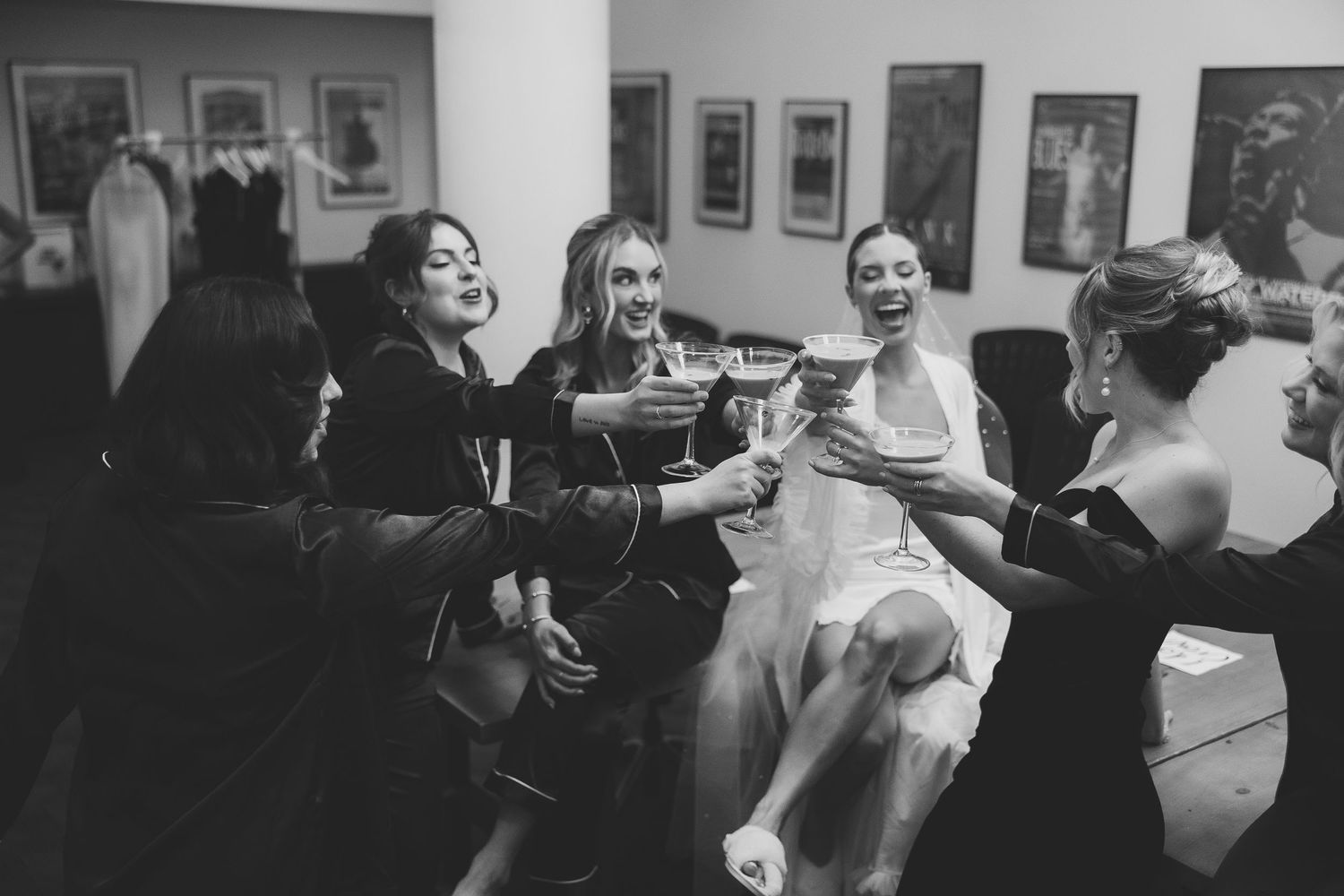 Black and white photo of guests enjoying themselves at a wedding reception.
