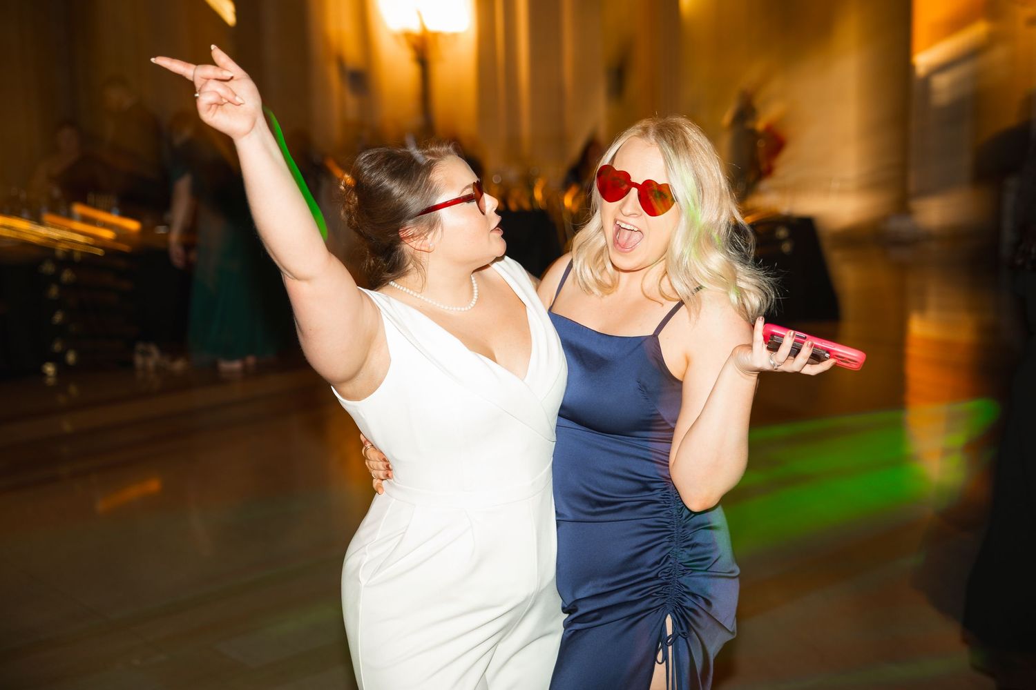 People dance and celebrate at an energetic wedding reception party.