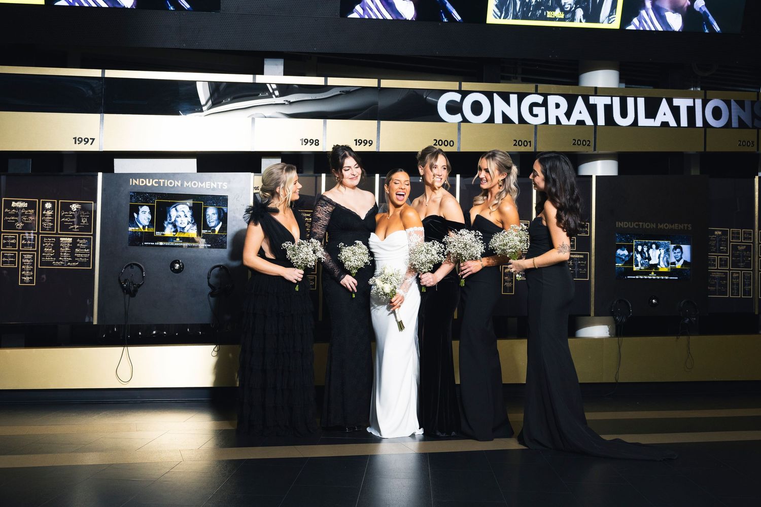 Modern wedding venue with digital displays and mood lighting for evening celebration.