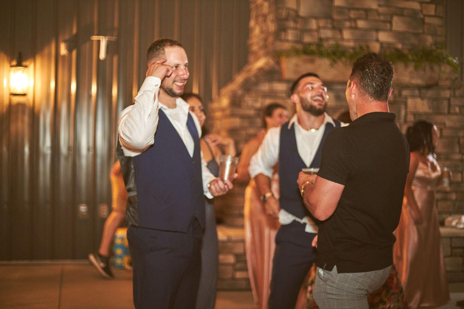 Animated conversation between wedding guests during an evening reception.