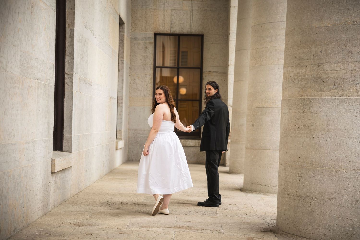 Artistic wedding photos showing a couple's journey through an elegant columned hallway.