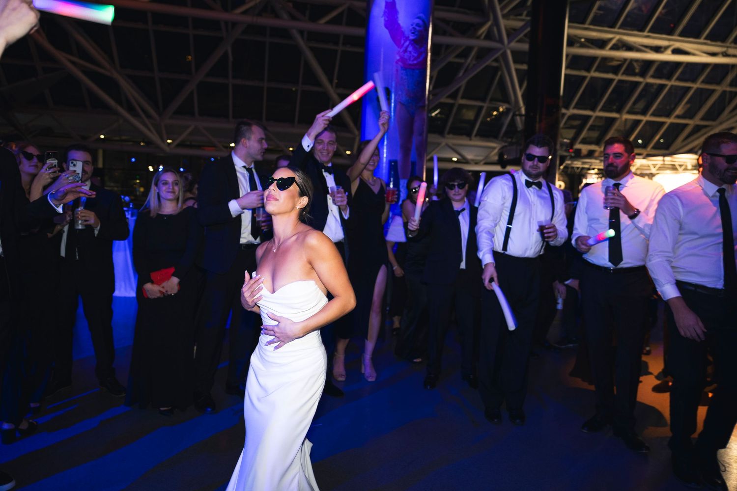Dance floor at wedding reception lit with blue and purple lighting effects.