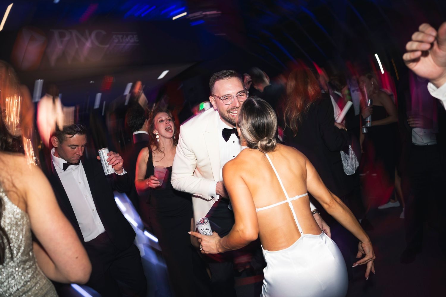 Lively dance floor scene with guests enjoying the wedding celebration.