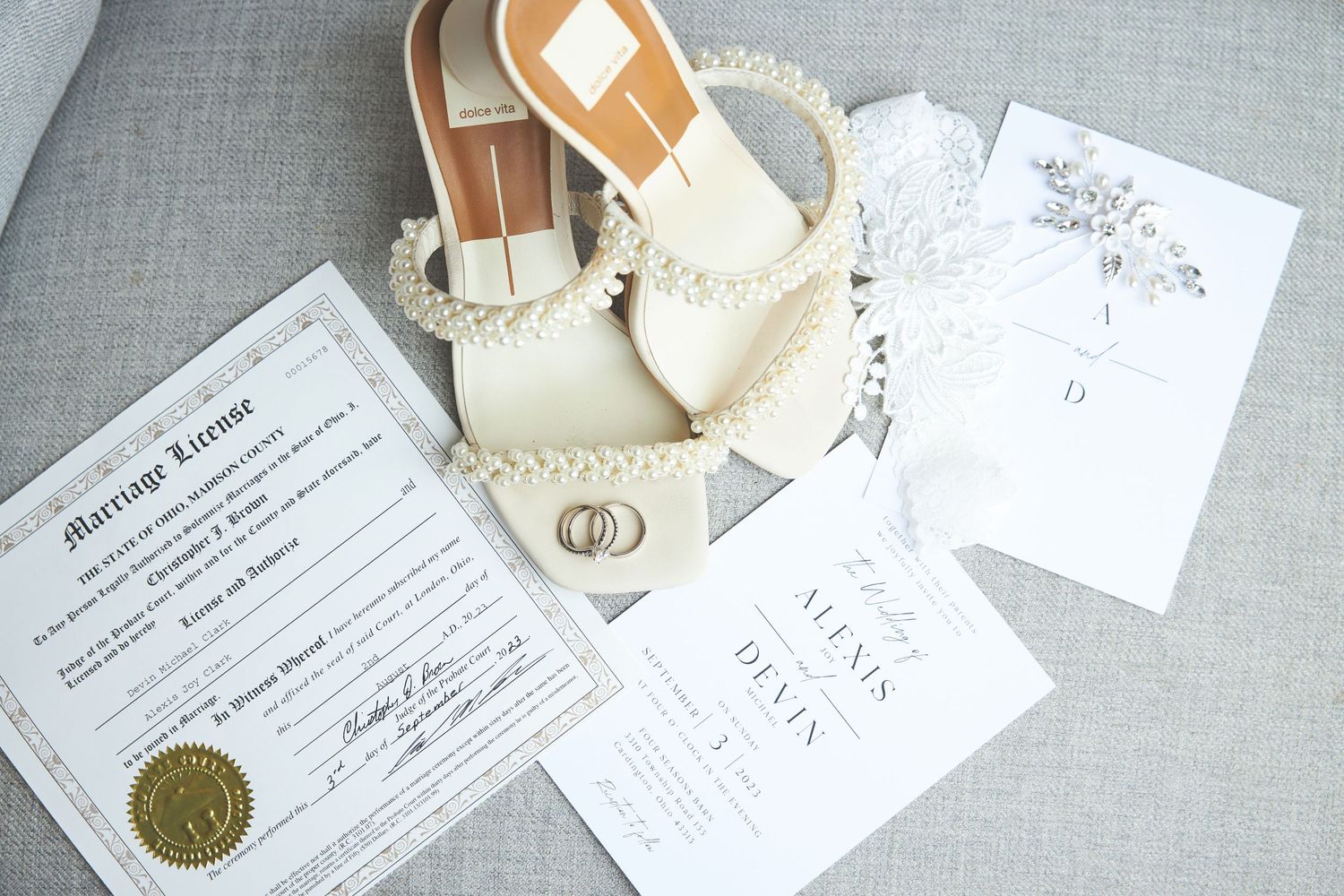 Classic wedding stationery and invitation suite displayed on soft gray linen background.