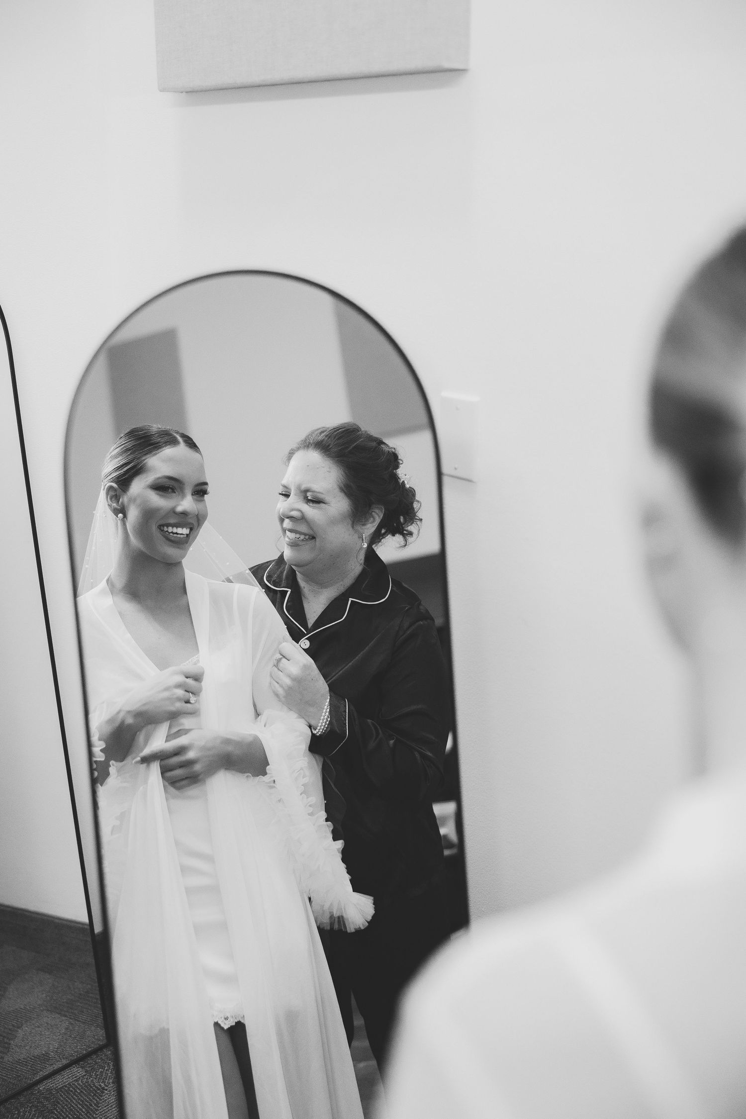 Black and white candid moments during wedding preparation.