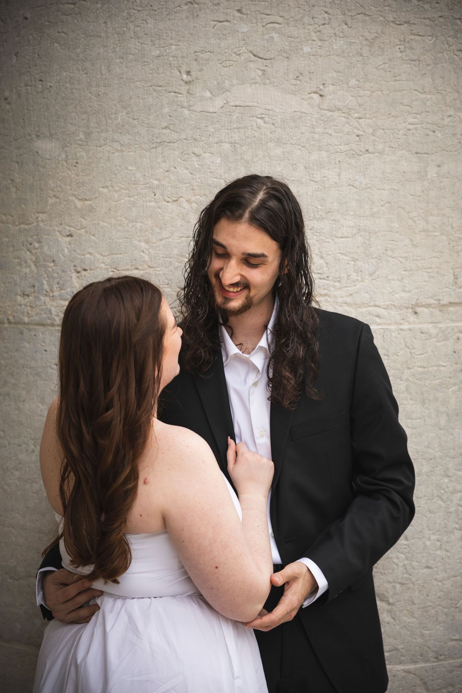 Candid moments of a couple laughing and embracing during their photo session.