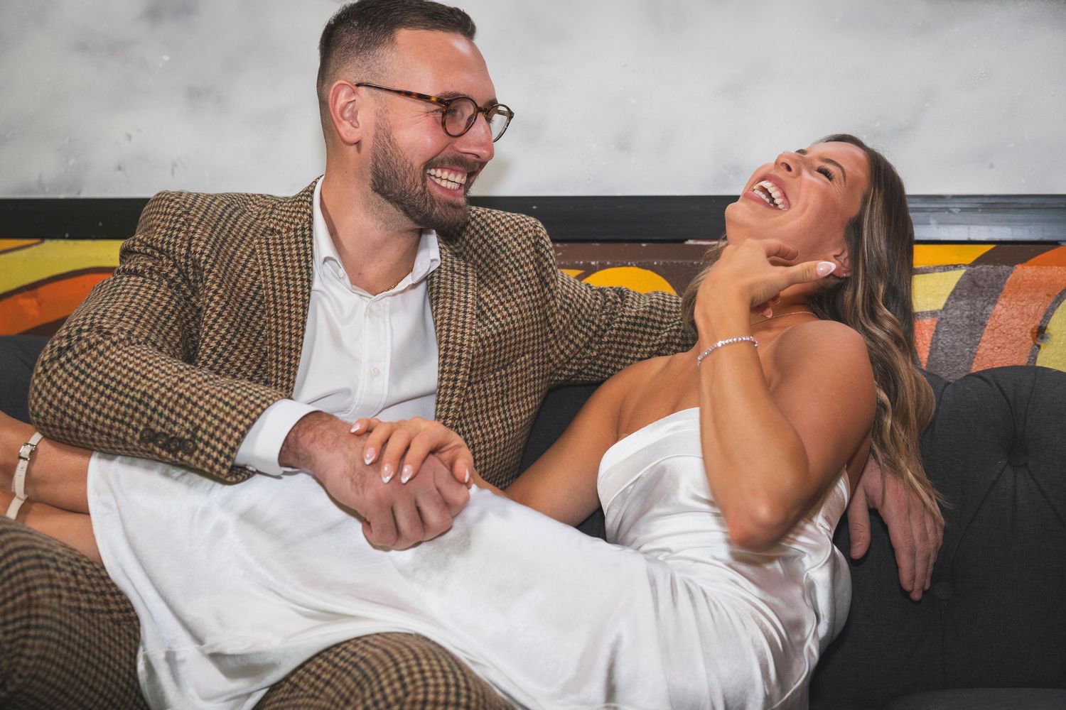 Couple enjoying a romantic evening together at a modern bar setting.