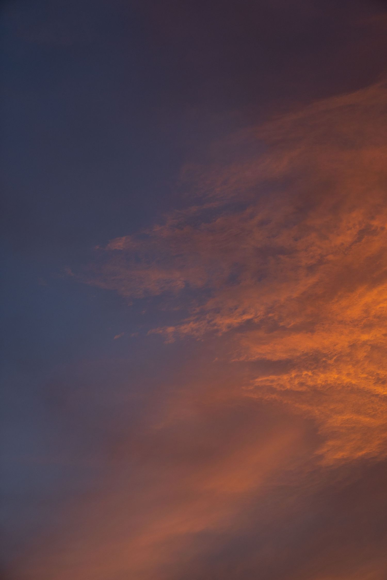 Dramatic orange and purple sunset clouds create a vibrant contrast in the evening sky.