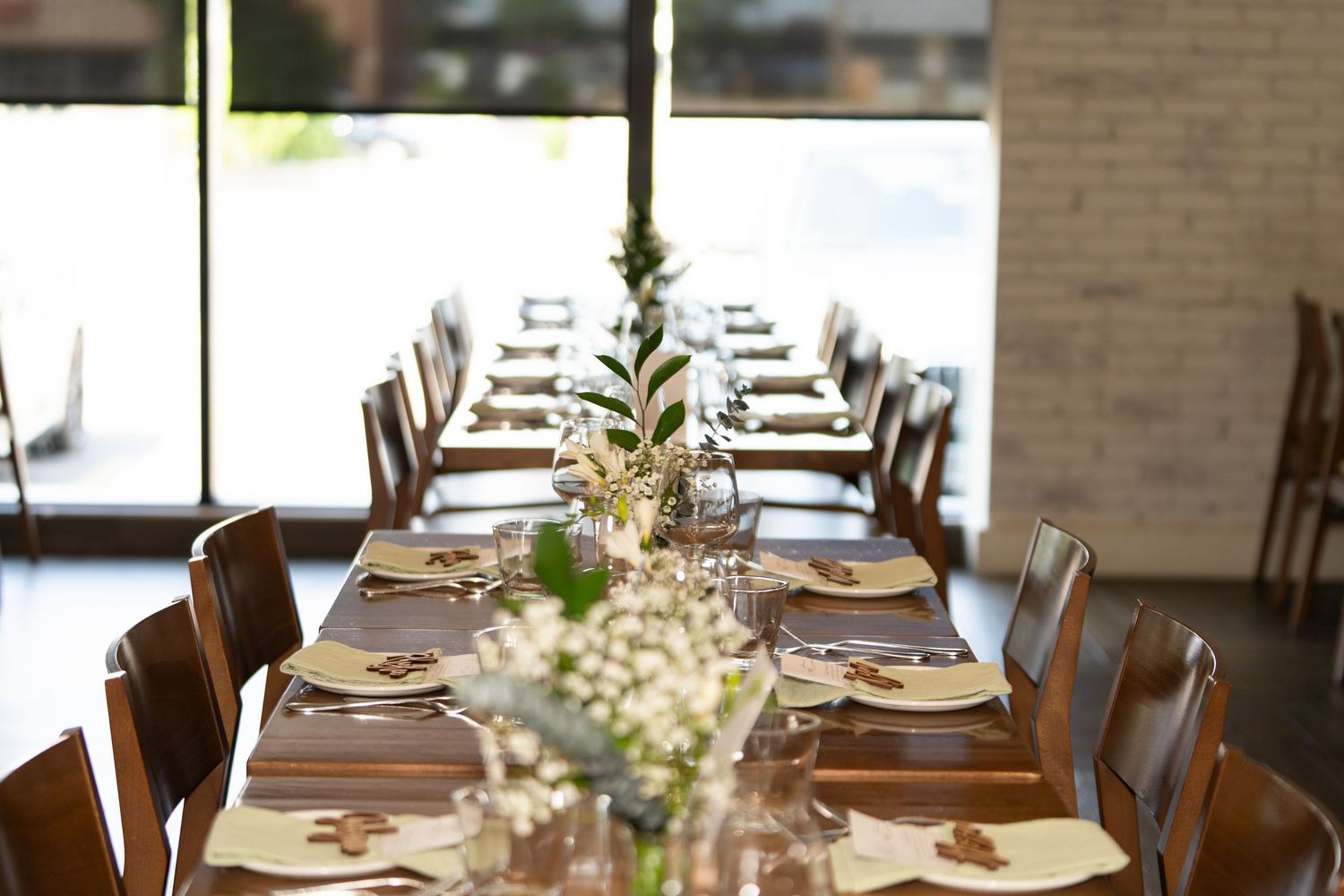 Elegant table setting with delicate flower centerpieces and natural lighting.