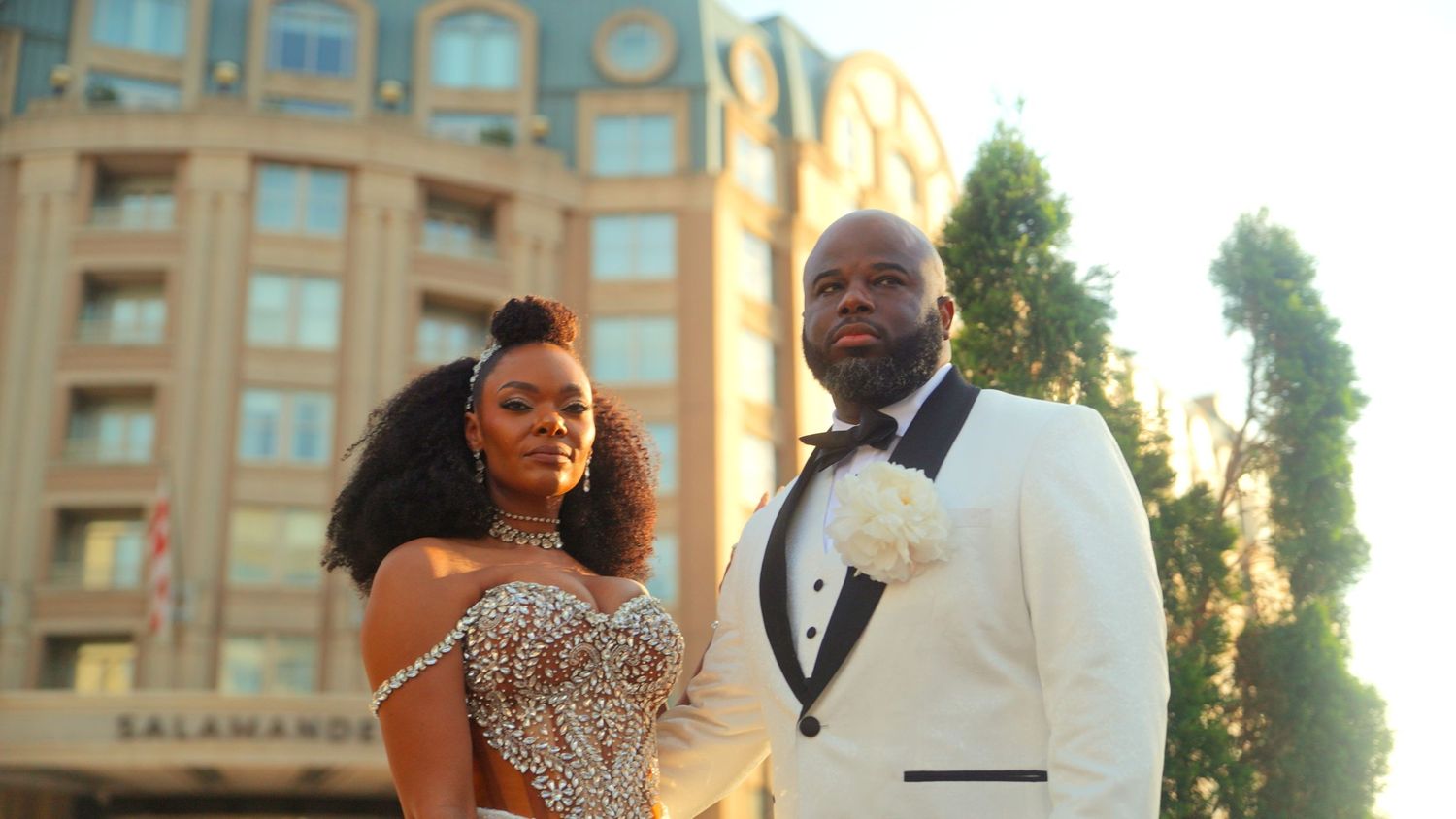 Elegant wedding couple posing at golden hour outside the Salamander Hotel, bride in sequined gown.