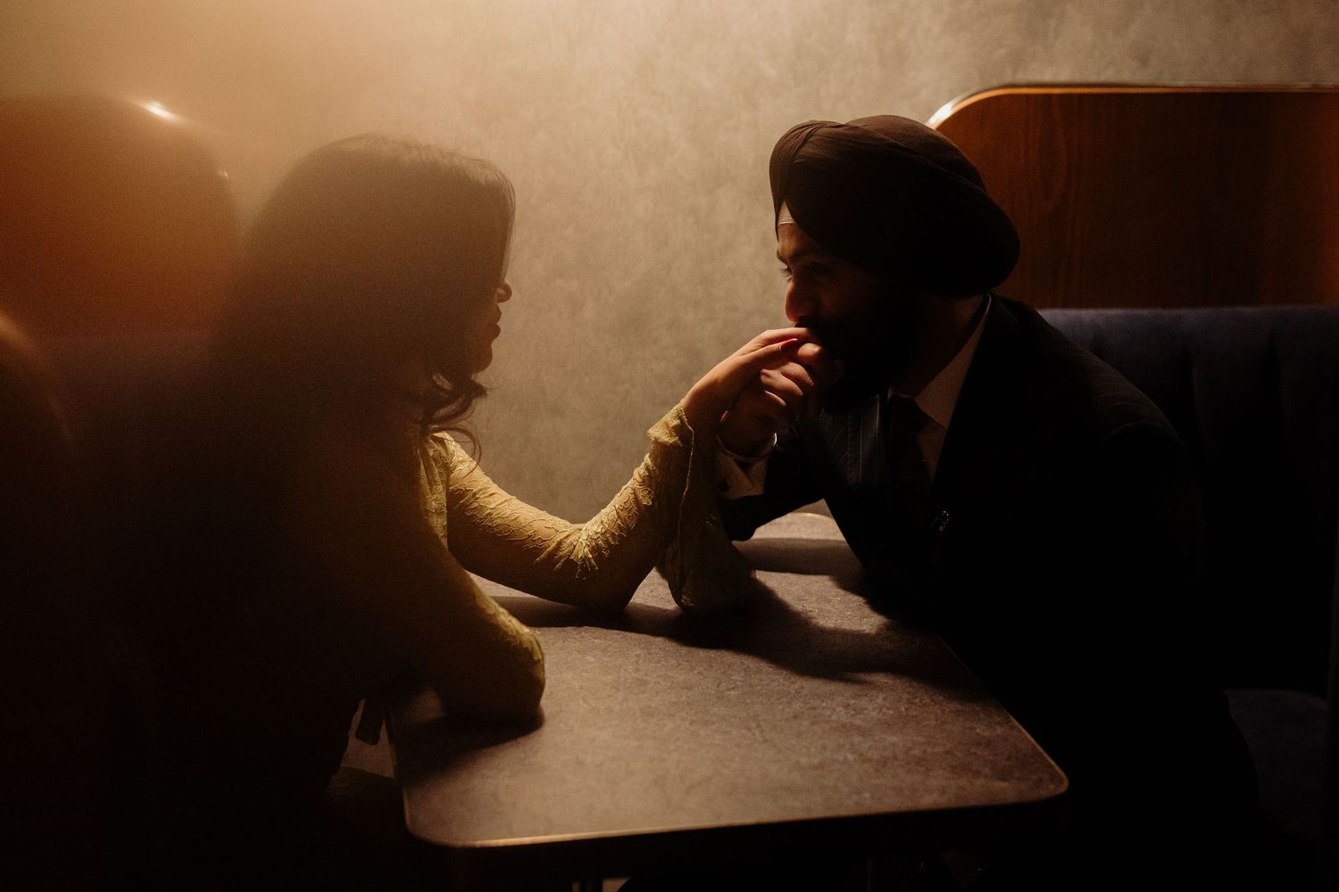 Dramatic silhouette shot in dimly lit room with atmospheric lighting.
