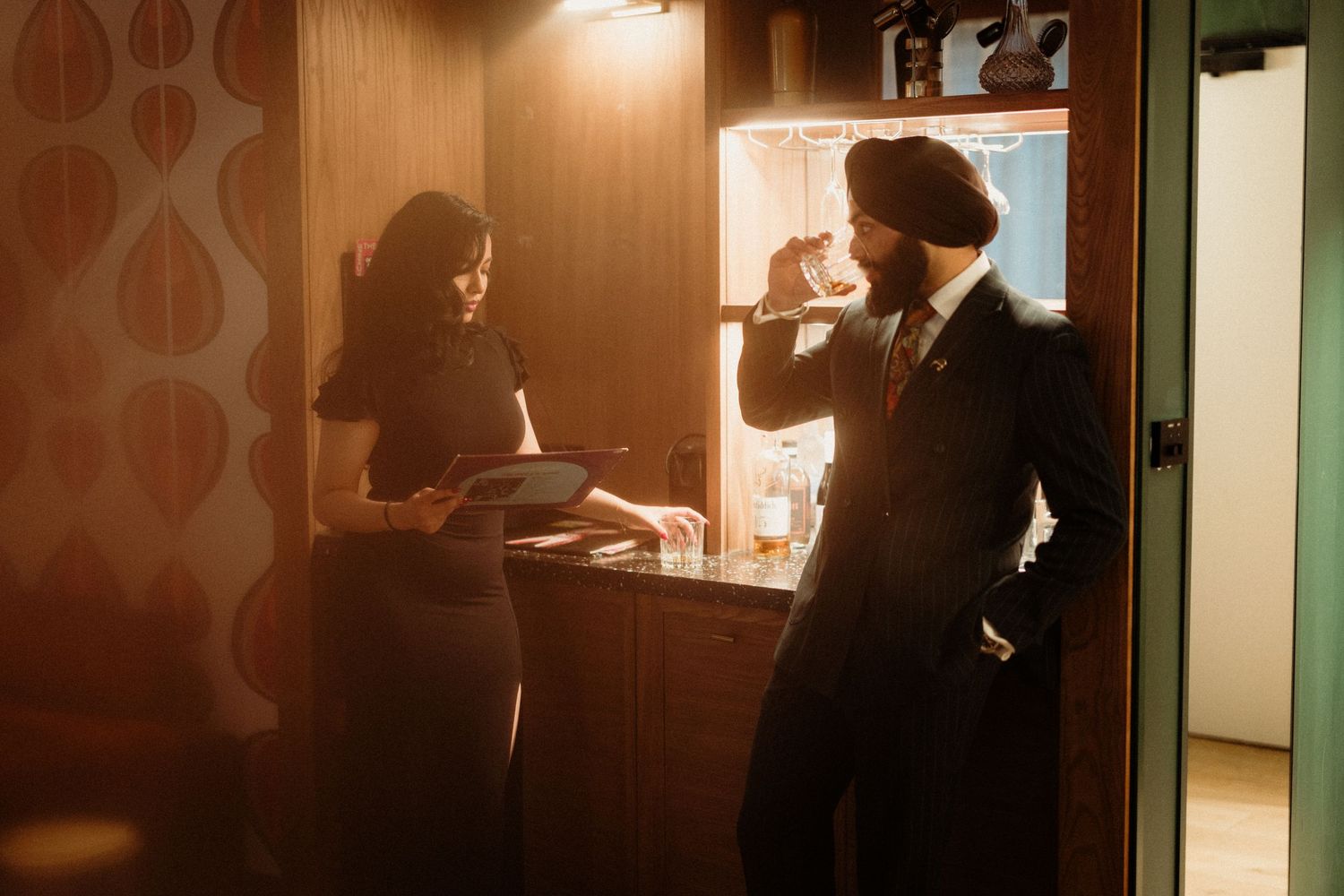 A romantic silhouette scene captured in warm indoor lighting.