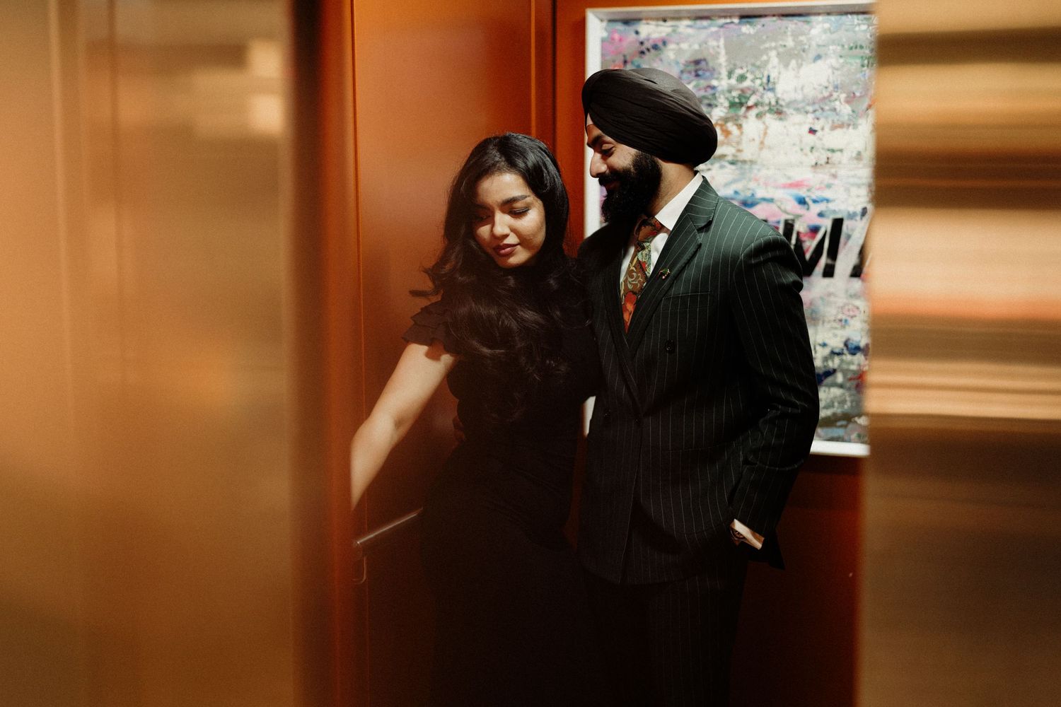 An intimate indoor moment captured in warm orange tones.