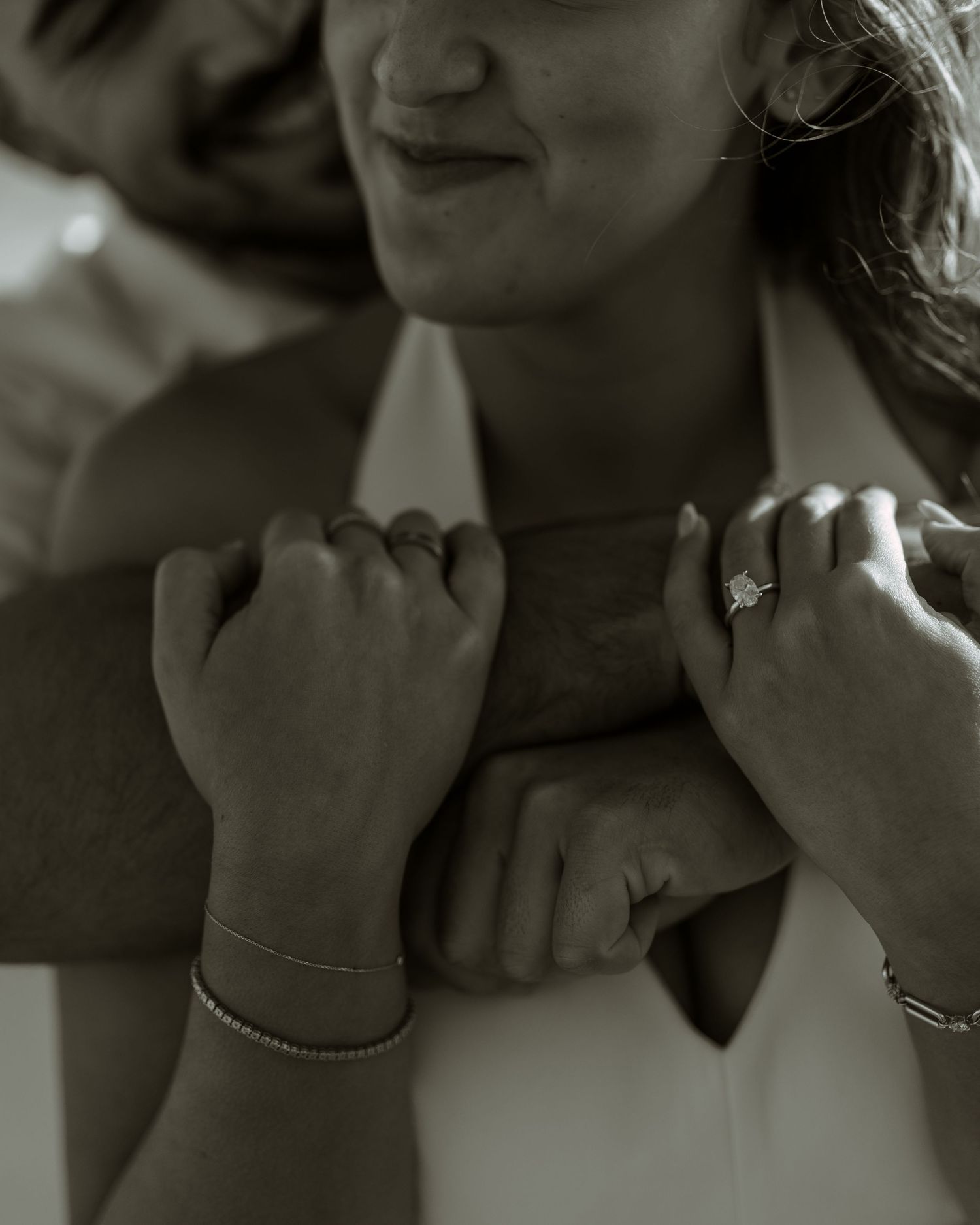 Black and white close-up shot of elegant jewelry and romantic gestures.