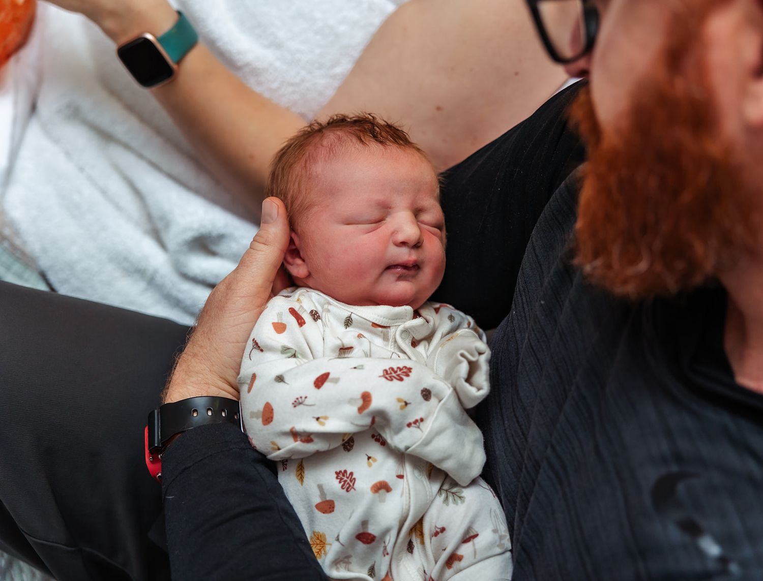 Dad looking over his new daughter that is minutes old after being born at the birth center of midland