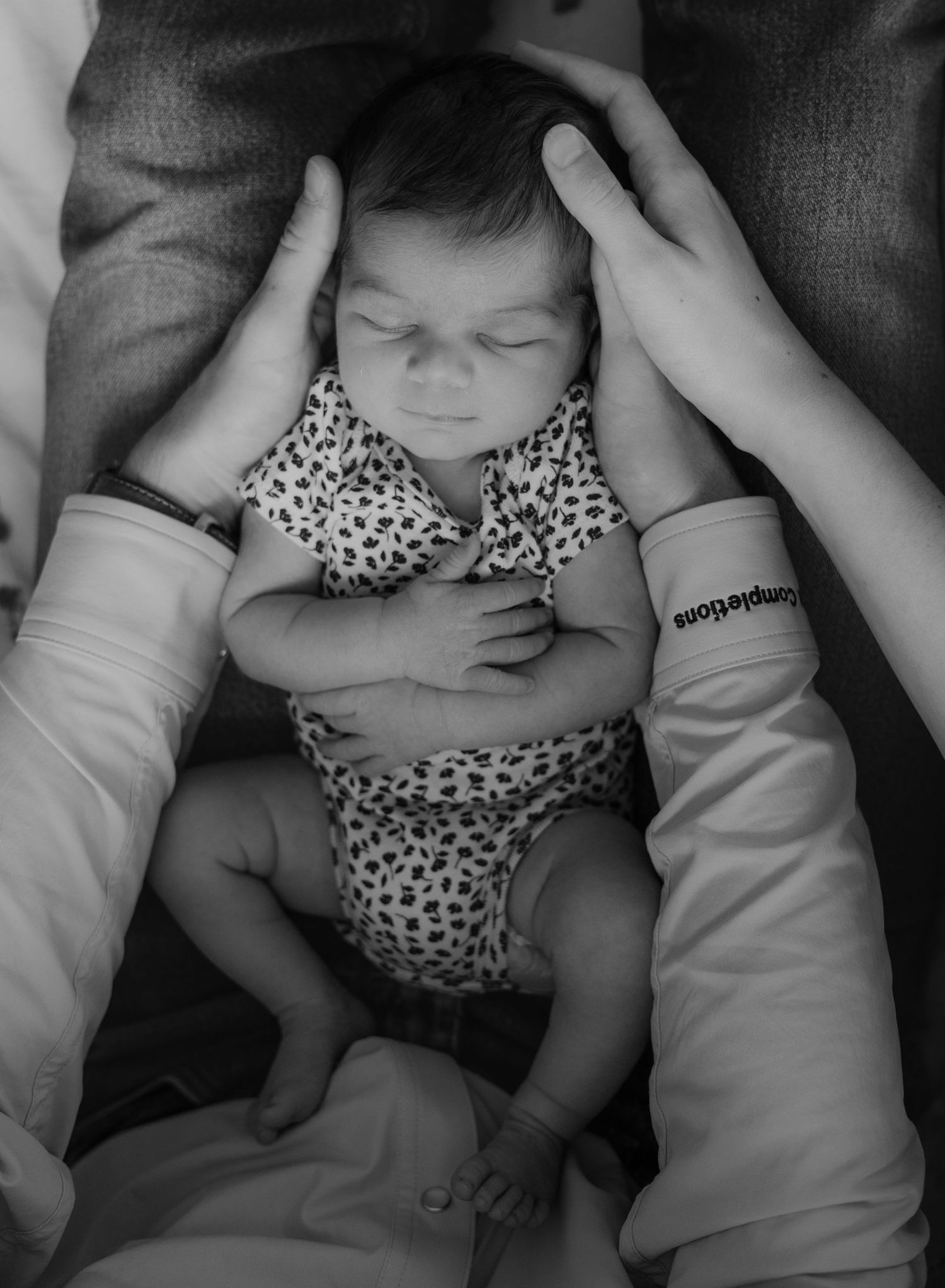 mom and dad admiring newborn baby girl during in home fresh 48 session