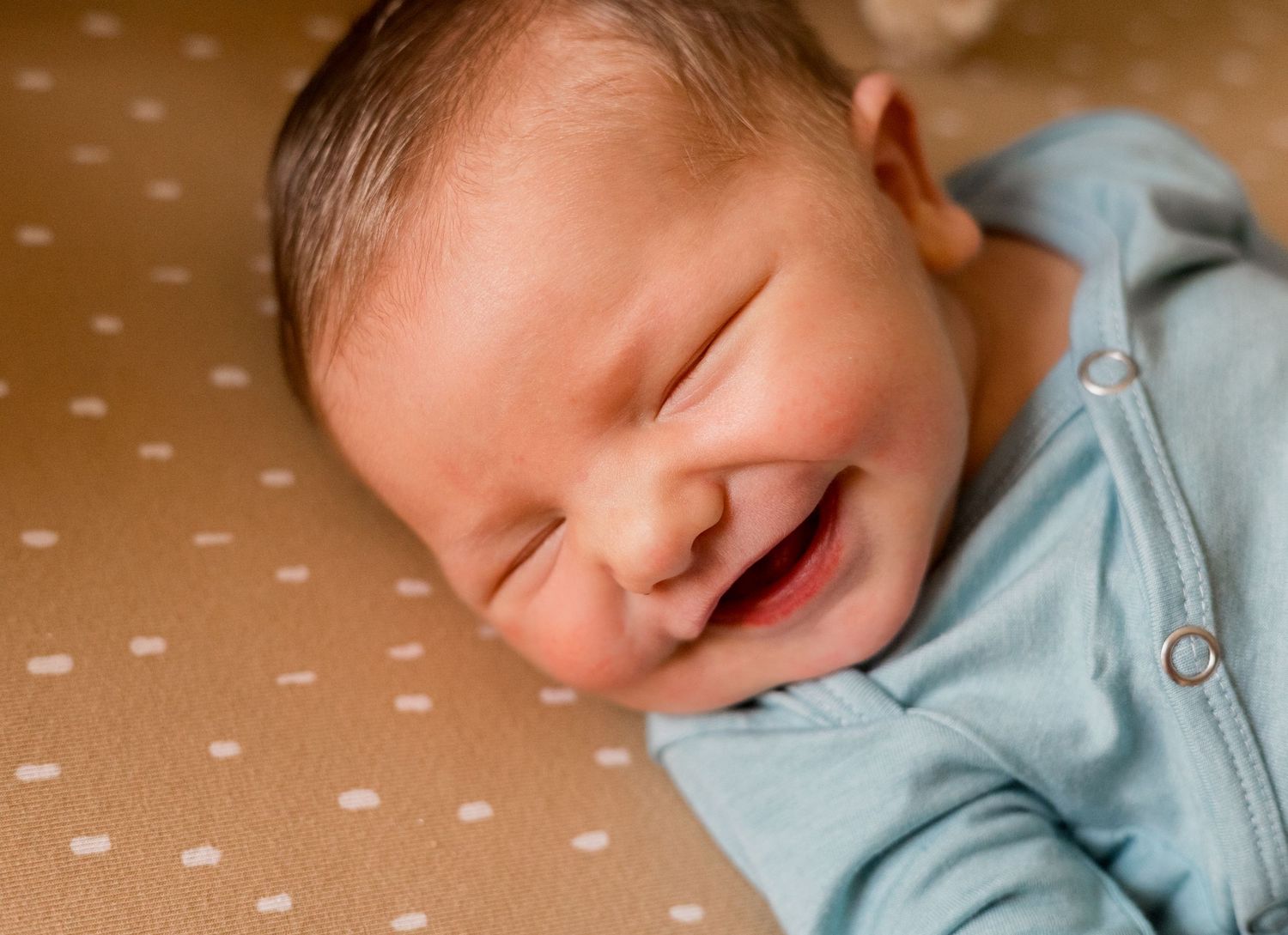 newborn smiling for photo during fresh 48 session