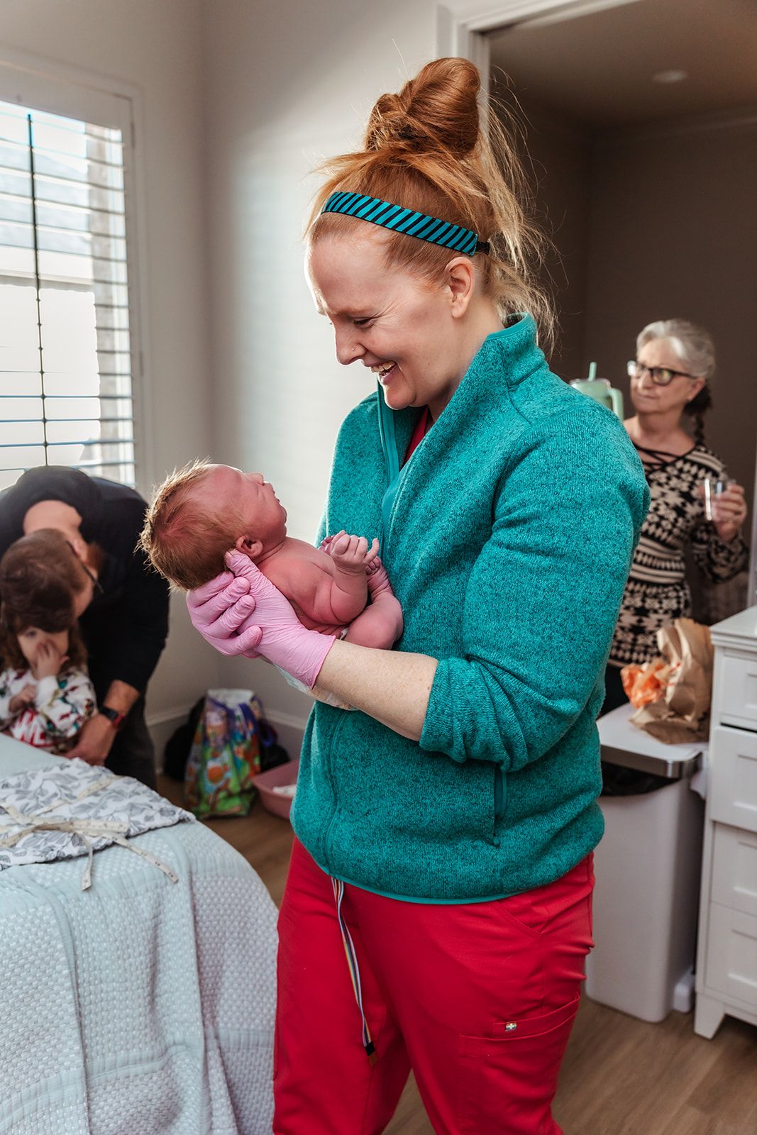 midwife Jamie smiling at newborn baby after newborn exam at The Birth Center of Midland