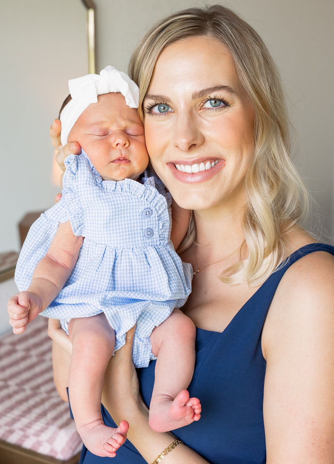 mom smiling with her newborn baby girl at fresh 48 session