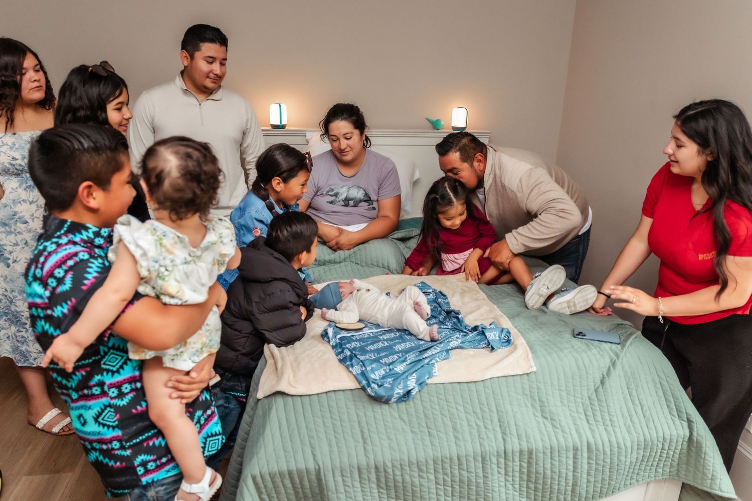 large family gathering after the birth of a baby at the birth center of midland