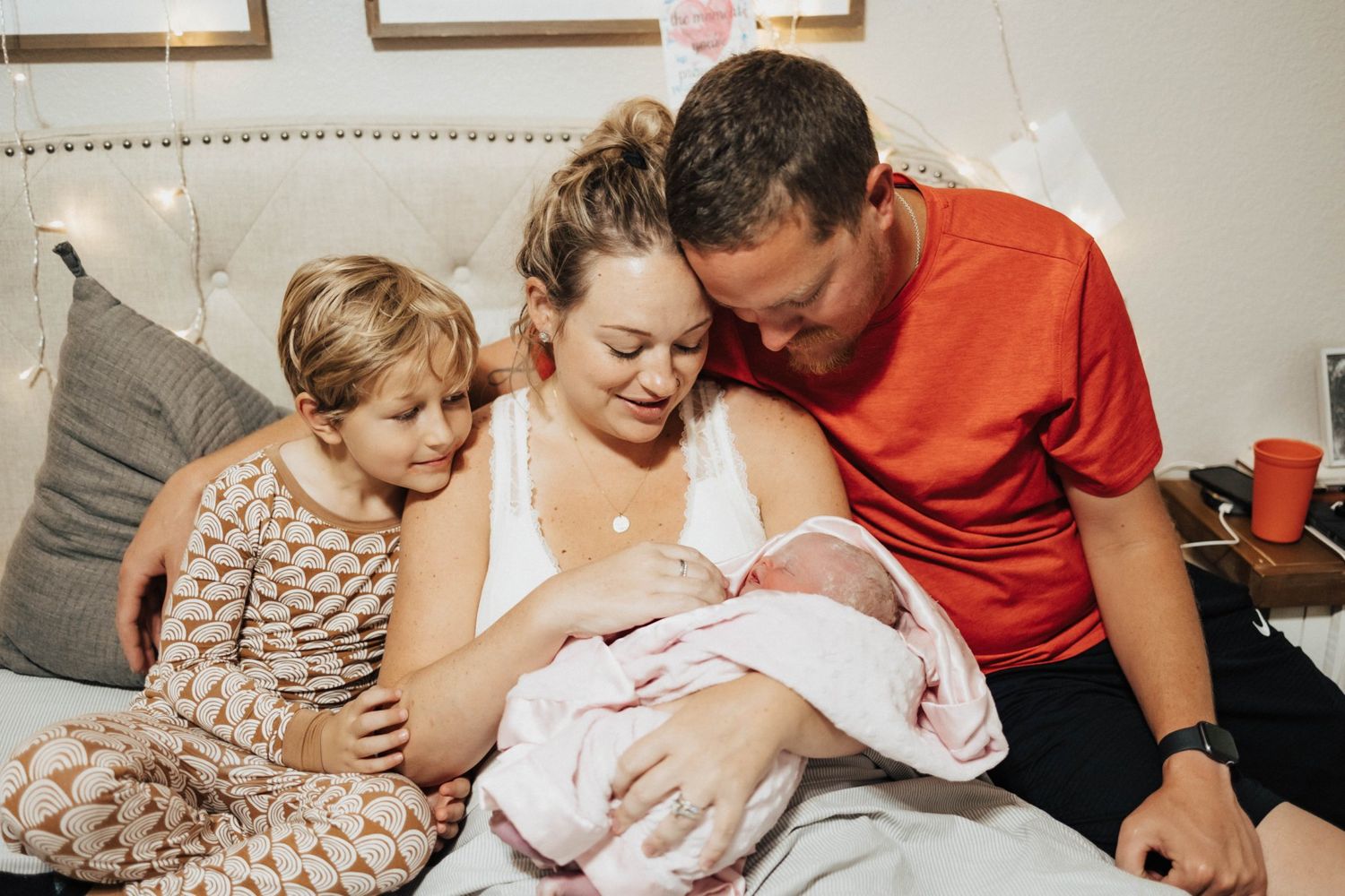Admiring new baby in bed after a home birth to a surprise gender baby girl