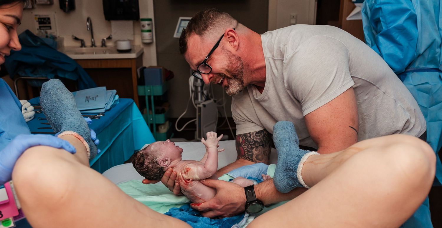 Dad catching his own baby after vaginal unmedicated hospital birth at midland memorial hospital