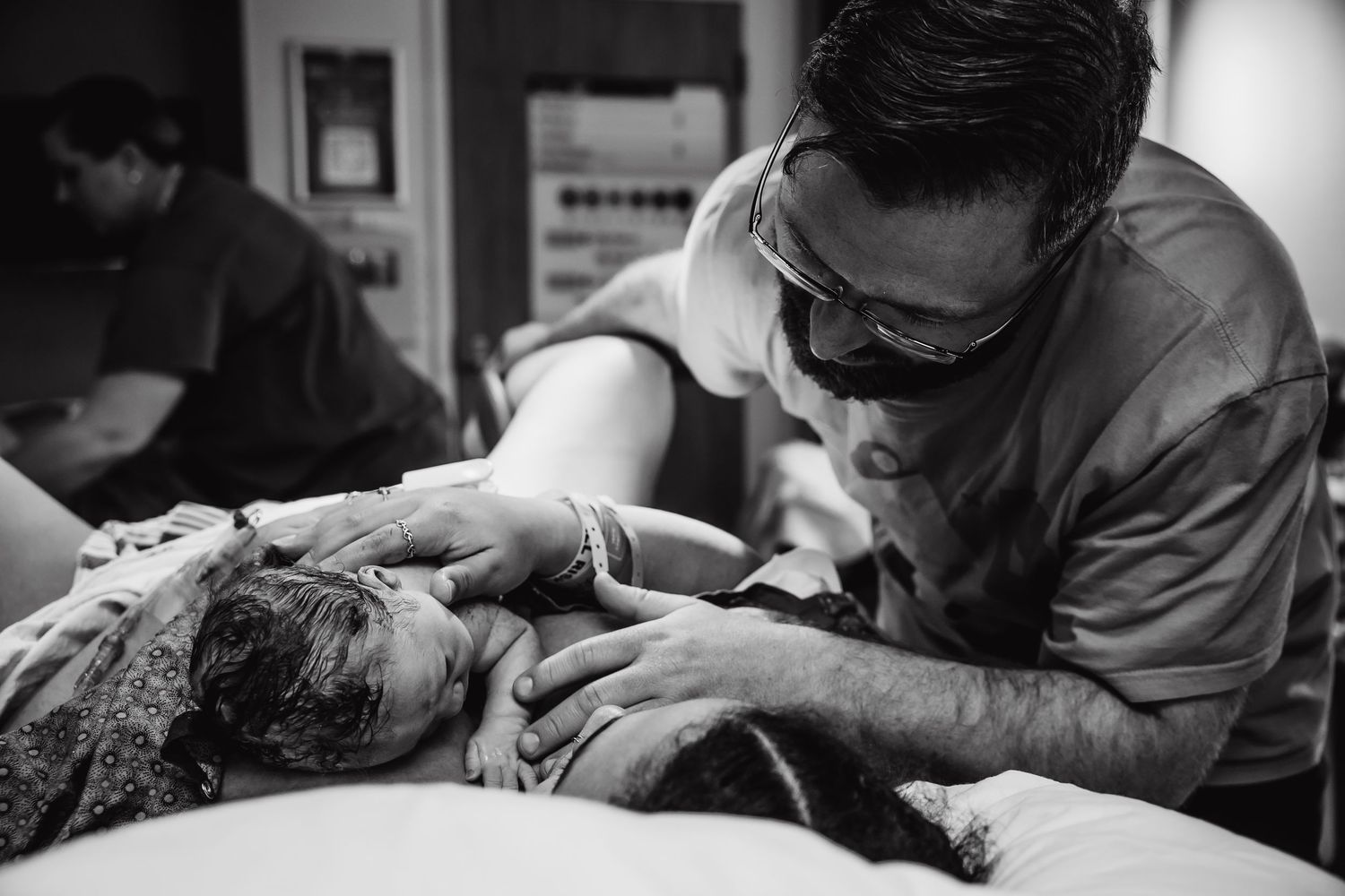 dad admiring his wife and new baby