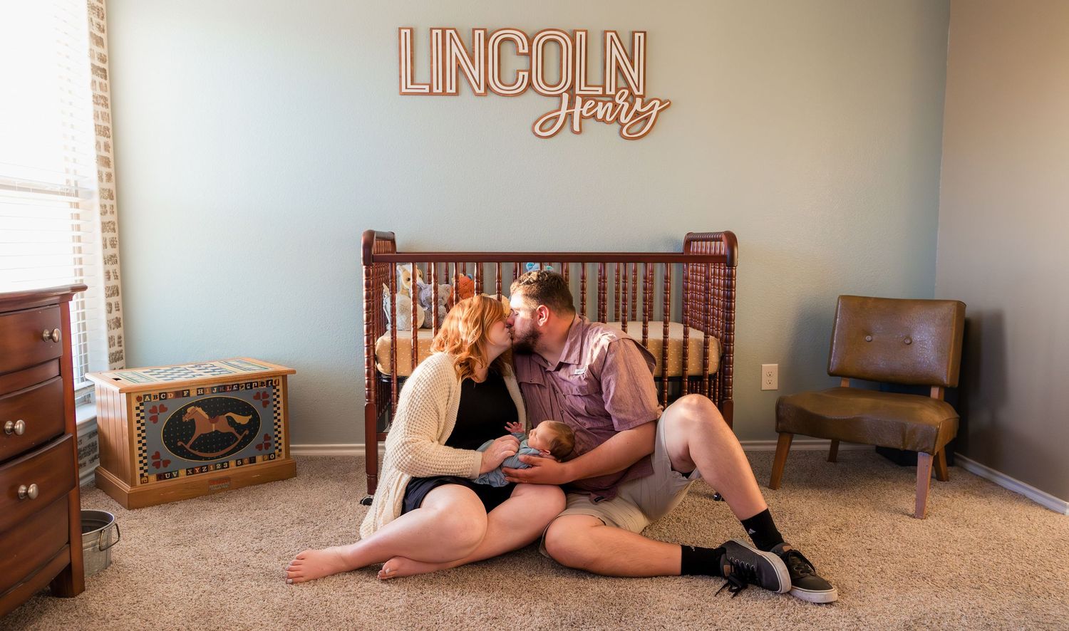 new parents kissing in newborn nursery during fresh 48 session