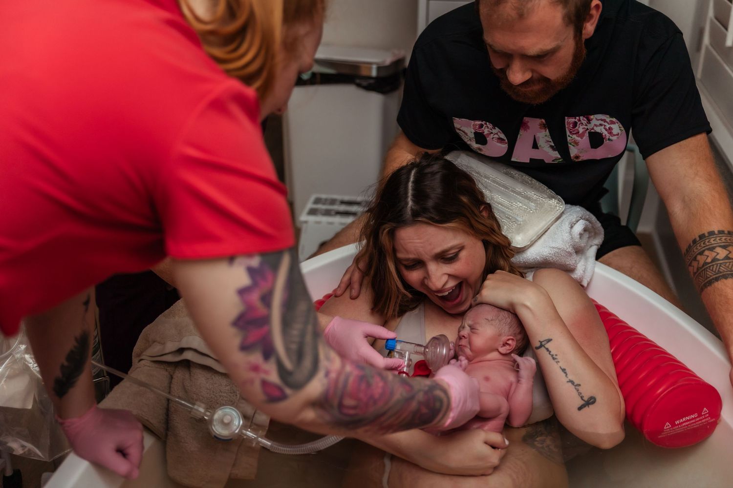 Mom amazed at the birth of her first baby girl after 5 boys born at a free standing birth center in a large tub at Birth Center of Midland