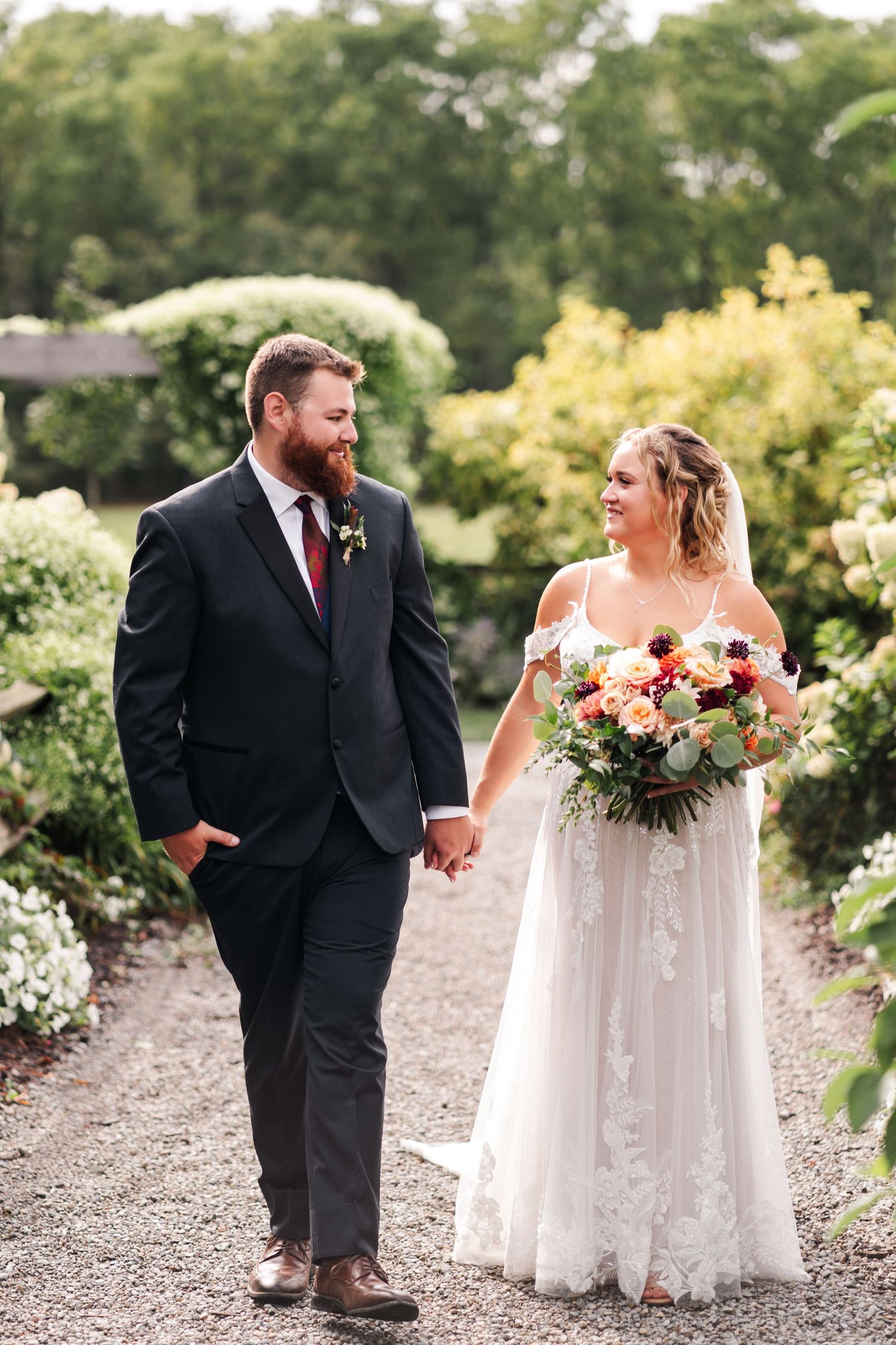 Intimate wedding photos captured on a gravel path surrounded by garden greenery.
Wedding in Niagara.