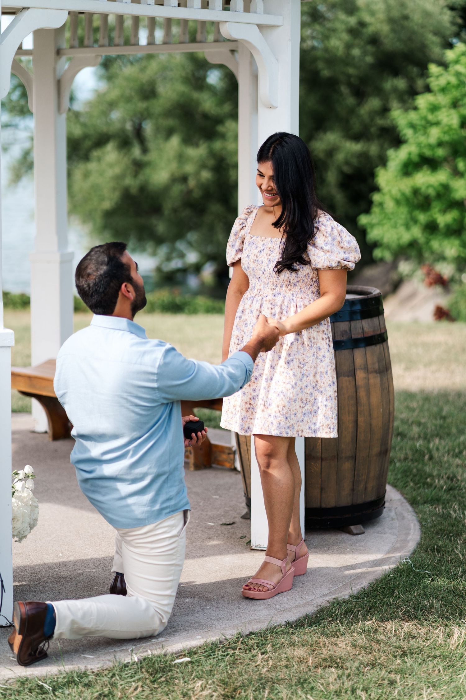 A proposal moment captured under a white pergola with rustic barrel decor.
Niagara proposal photos.