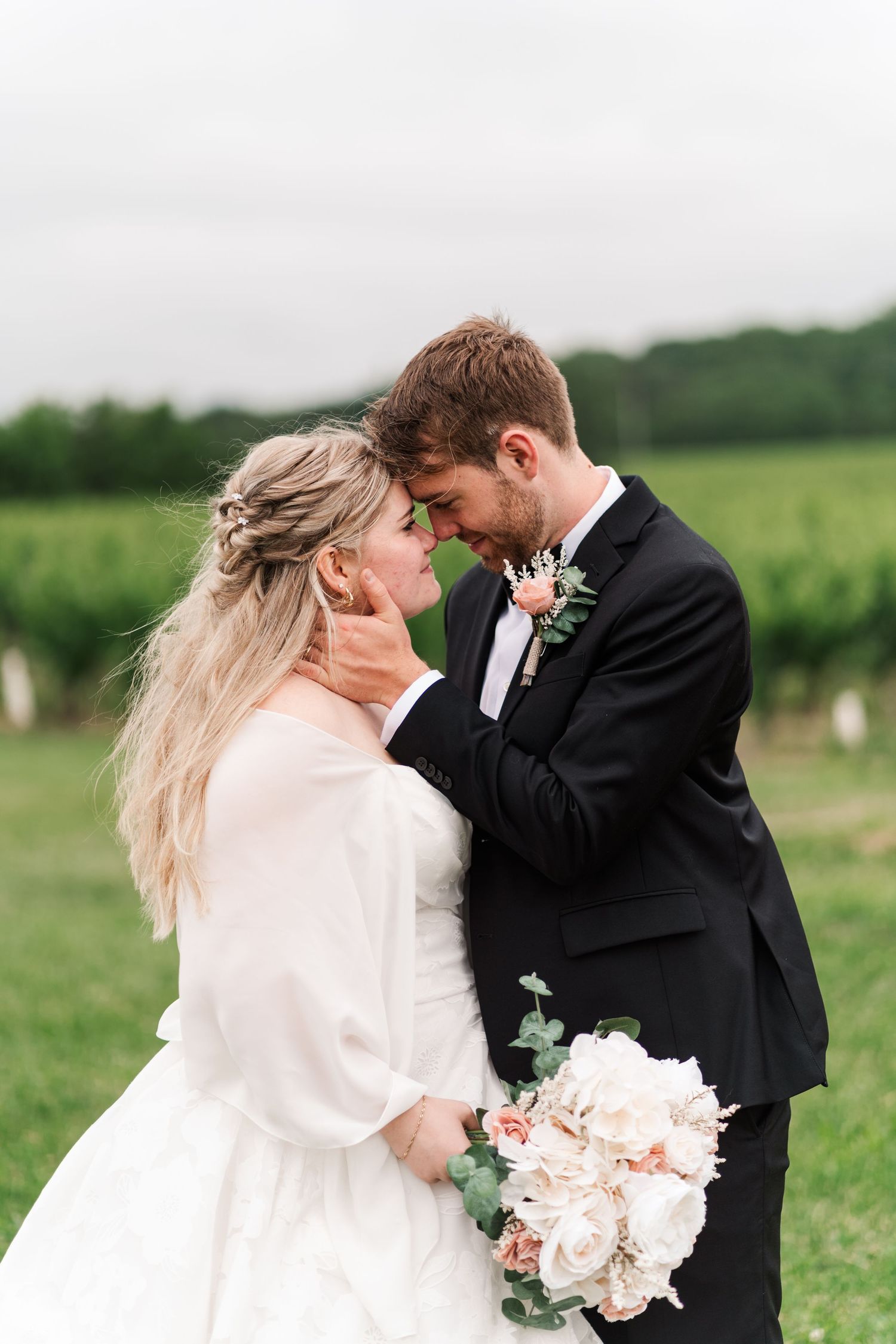 Romantic winter wedding portraits in a field with bride wearing white wrap.
Wedding in Niagara.