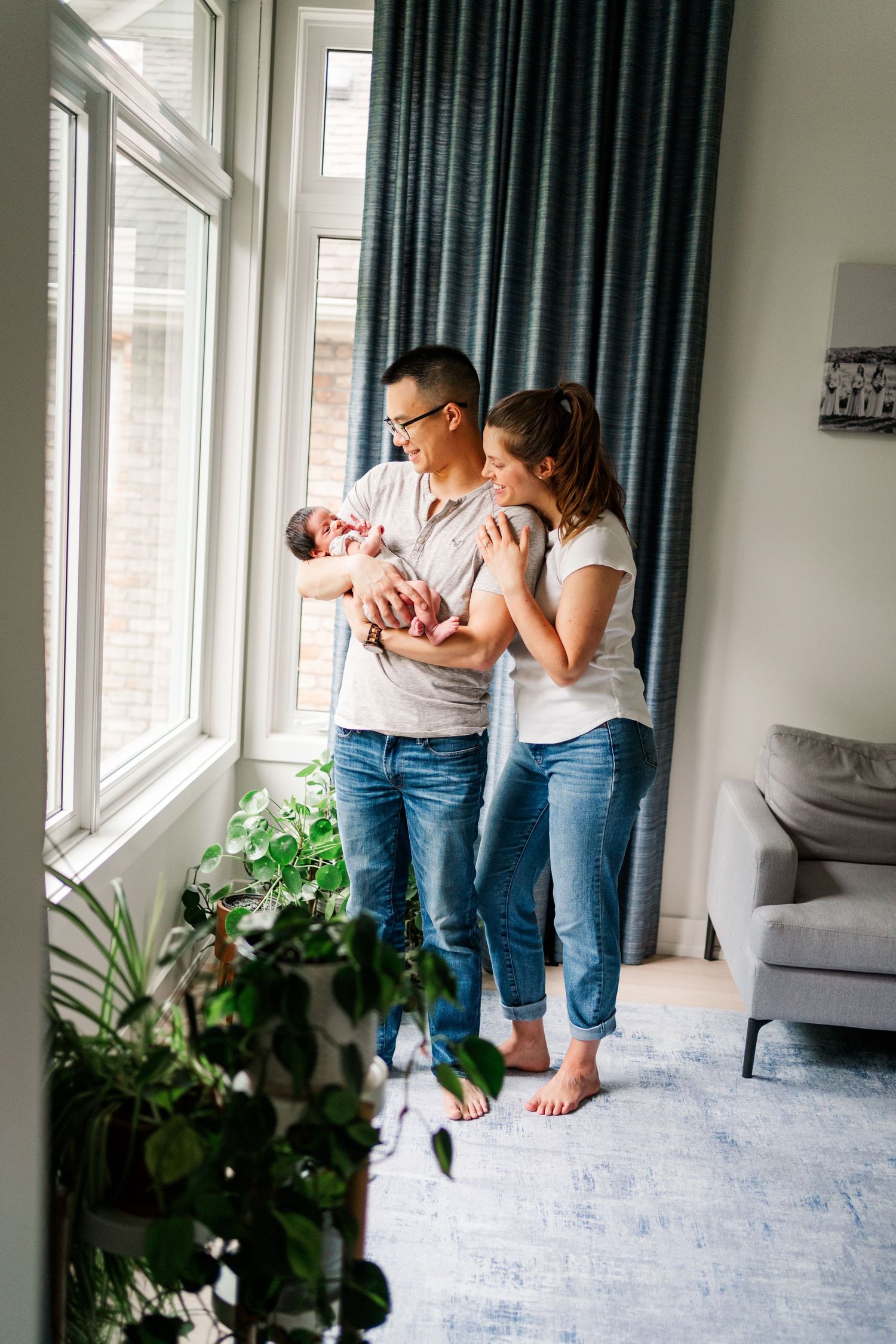 Family sharing intimate moments and cuddles in a bright modern living room.
Niagara newborn photos.