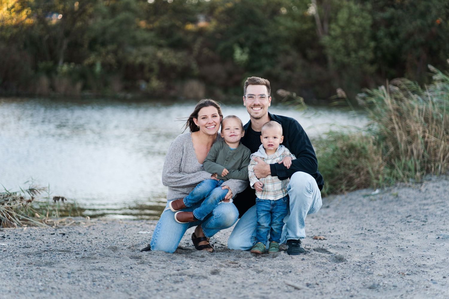 Family relaxing together on a rocky beach path during golden hour sunset.
Niagara family photos.
