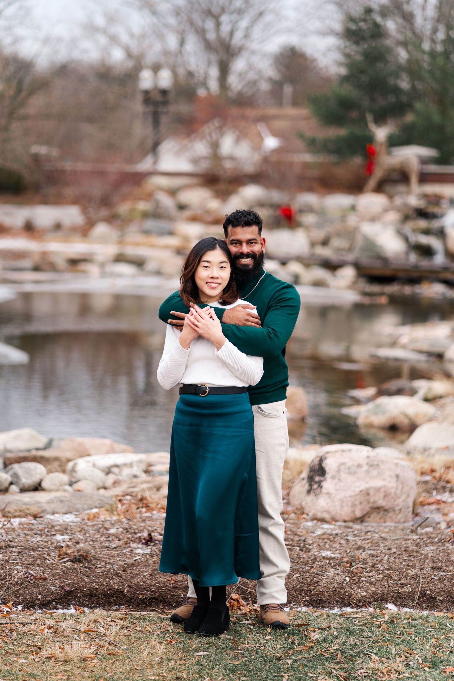 Couple sharing a tender moment by a rocky lakeshore in winter.
Niagara Engagement photos