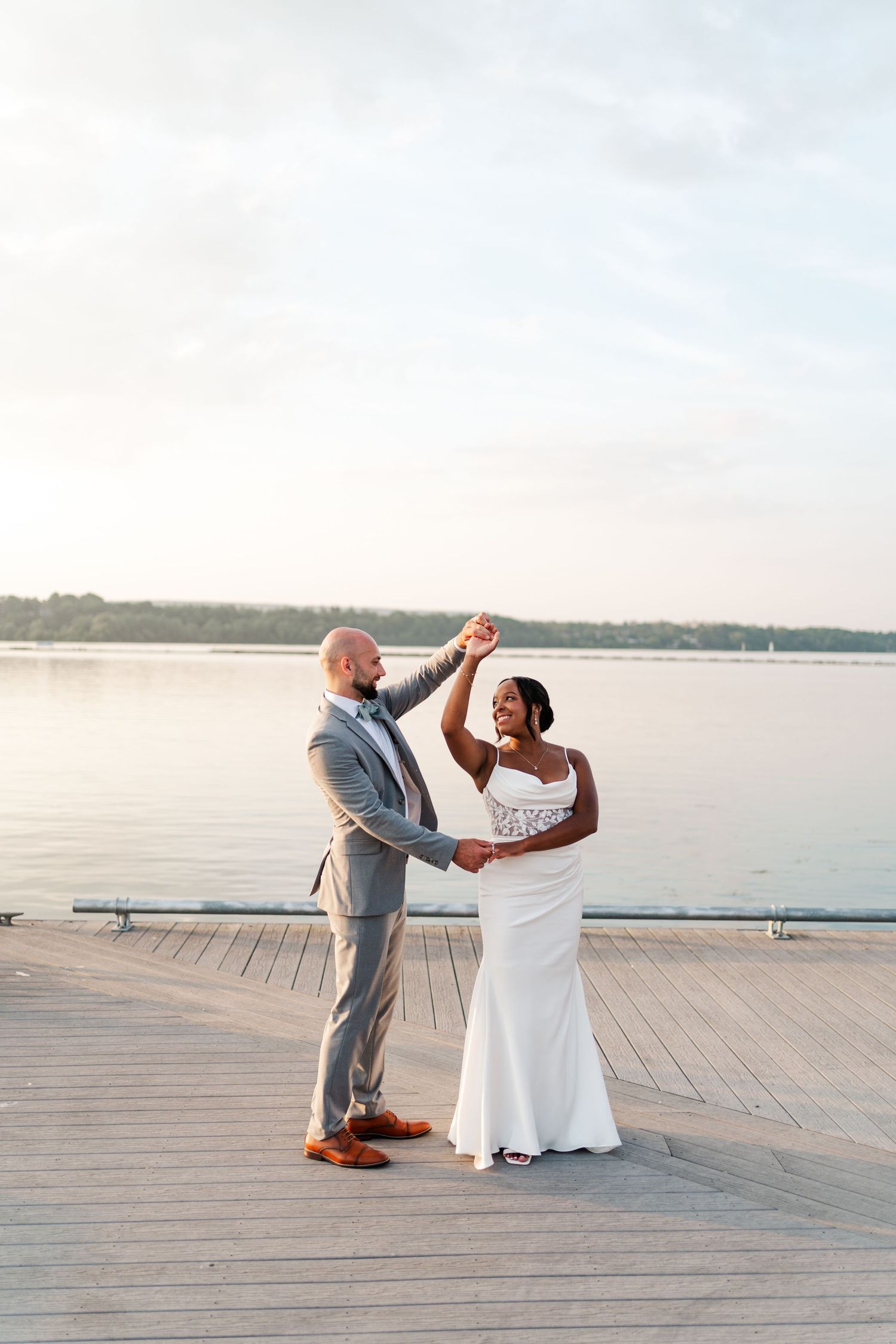 Couple performing romantic dance moves on a wooden pier at sunset.
Niagara wedding photos.